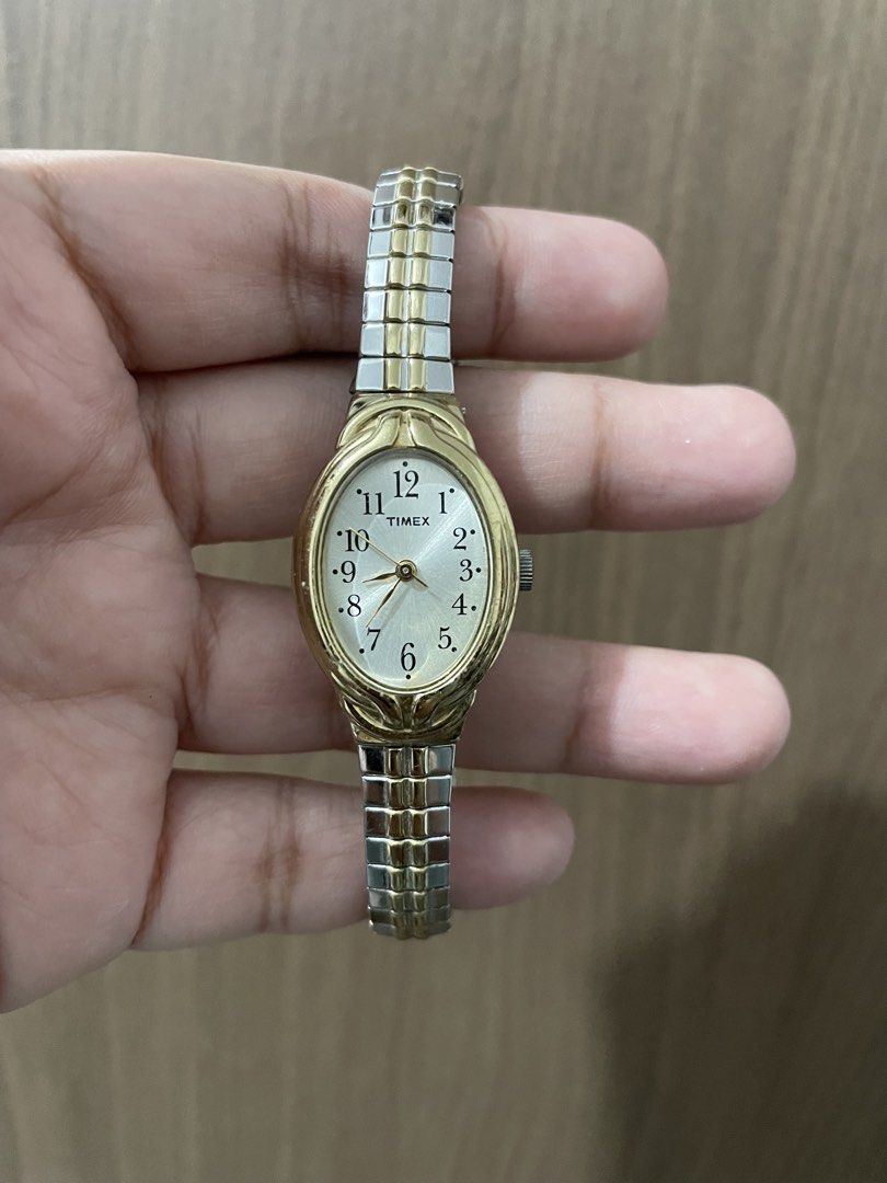 Timex Two-Tone Oval Watch (Category: Women's Watches) located in Taguig. Submitted by wisefire_d1567e (Listing ID 1464857700, Image 1). Description: - Brand: Timex Quartz - Dial: Clean silver dial with bold black numbers - Bezel & Case: Gold-tone oval bezel with stainless steel back - Strap: Two-tone silver and gold flexible expansion band (stretchable, fits most wrists) - Battery: Uses SR 626 SW - Condition: Working hands, clean face, ready to w