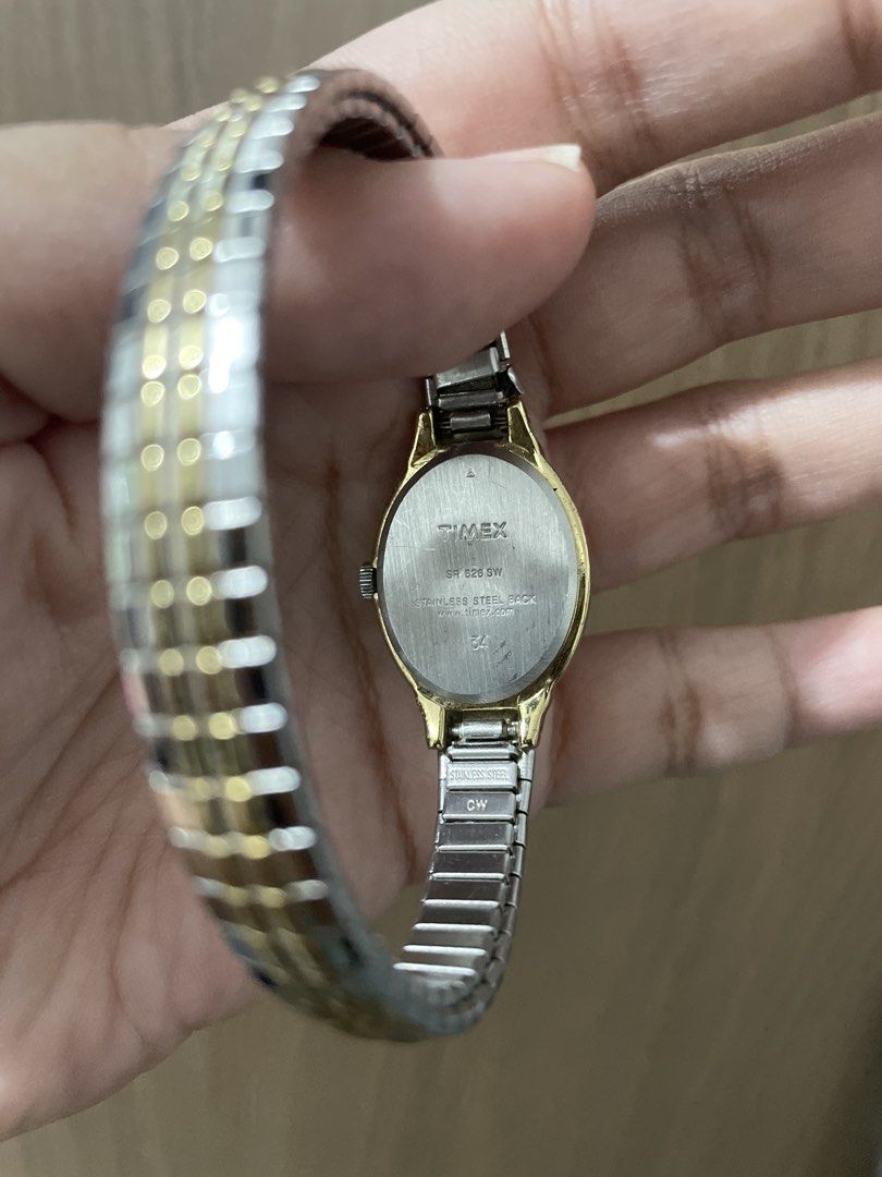 Timex Two-Tone Oval Watch (Category: Women's Watches) located in Taguig. Submitted by wisefire_d1567e (Listing ID 1464857700, Image 2). Description: - Brand: Timex Quartz - Dial: Clean silver dial with bold black numbers - Bezel & Case: Gold-tone oval bezel with stainless steel back - Strap: Two-tone silver and gold flexible expansion band (stretchable, fits most wrists) - Battery: Uses SR 626 SW - Condition: Working hands, clean face, ready to w