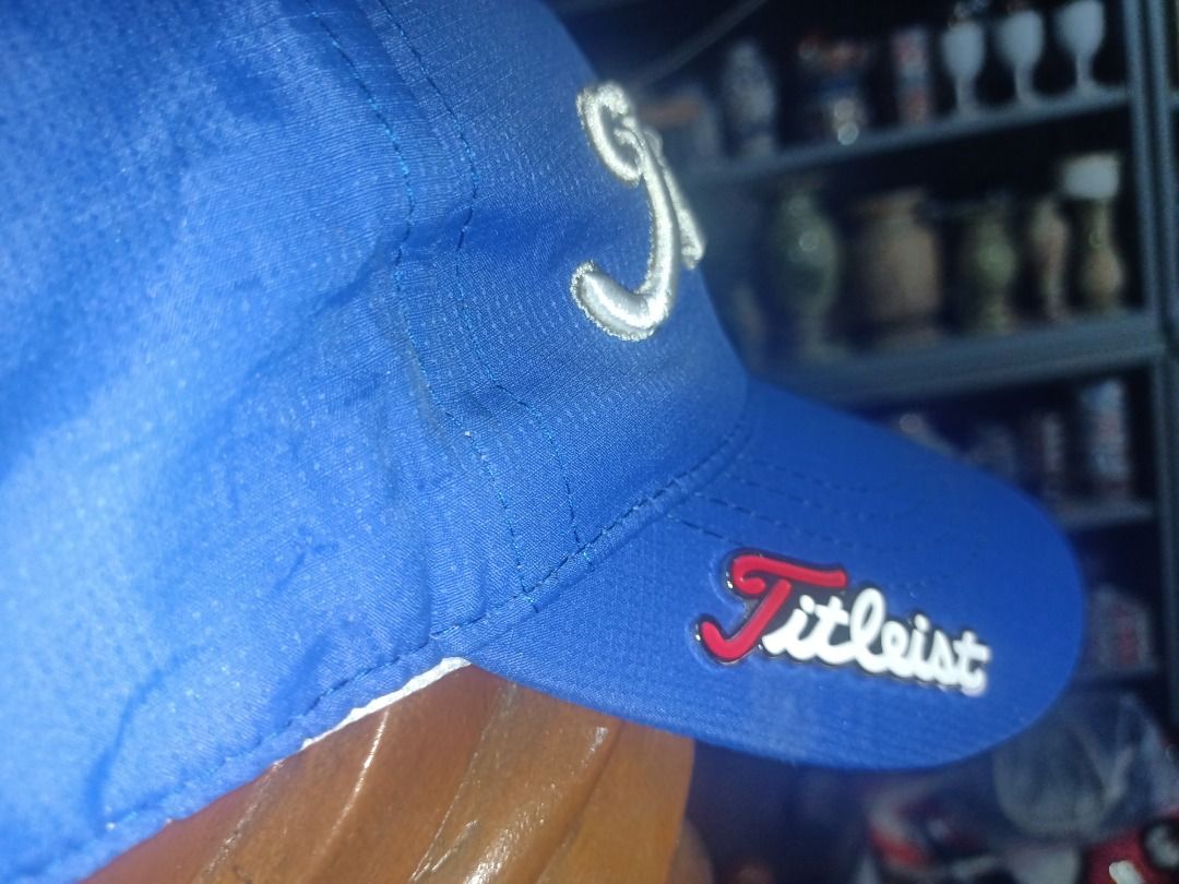 Titleist Blue Cap (Category: Caps & Hats) located in Munoz. Submitted by larryc1212 (Listing ID 1464900283, Image 2). Description: - Authentic Titleist cap in vibrant bright blue - Bold, raised white embroidery on the front panels - Stylish metal Titleist logo securely pinned on the brim side - Matching embroidery details above the adjustable back closure - Clean structured crown with branded interior seam taping - Convenient and adjustable velcr