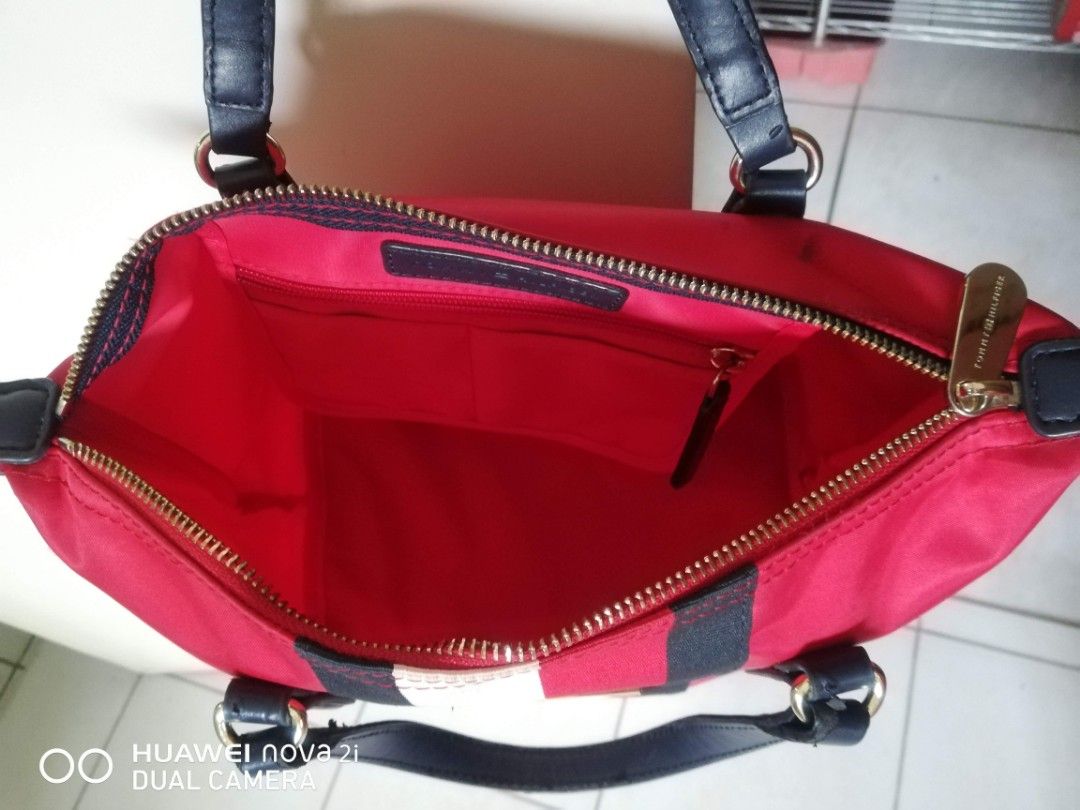 Tommy Hilfiger Bag (Category: Shoulder Bags) located in Iloilo. Submitted by pinspirewitha (Listing ID 1464774279, Image 2). Description: Authentic Tommy Hilfiger tote, preloved. Signs of use on handles (see photos). Clean interior, working zippers. The interior is clean, the zippers and hardware work, and the body fabric looks good. The peeling handles and frayed tabs are real wear, but the bag is fully functional..