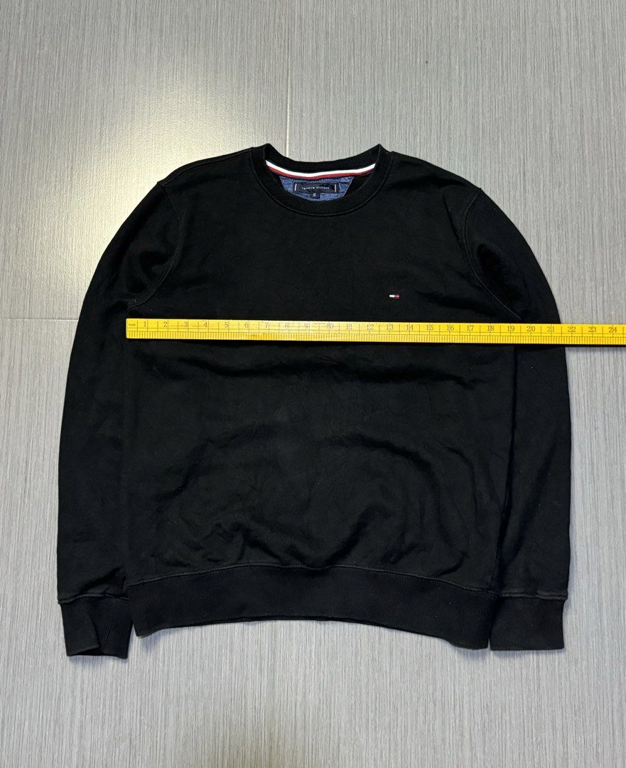 Tommy Hilfiger Black Sweatshirt Size S (Category: Coats, Jackets and Outerwear) located in Caloocan City. Submitted by mzcollection_349 (Listing ID 1464886098, Image 3). Description: - Brand: Tommy Hilfiger - Style: Crewneck Sweatshirt - Color: Solid Black - Size: S (Pit-to-pit: 21.5", Length: 27.5") - Details: Iconic embroidered logo on left chest, ribbed collar/cuffs/hem, striped trim tape inside neckline - Material: Soft and clean fleece fabri