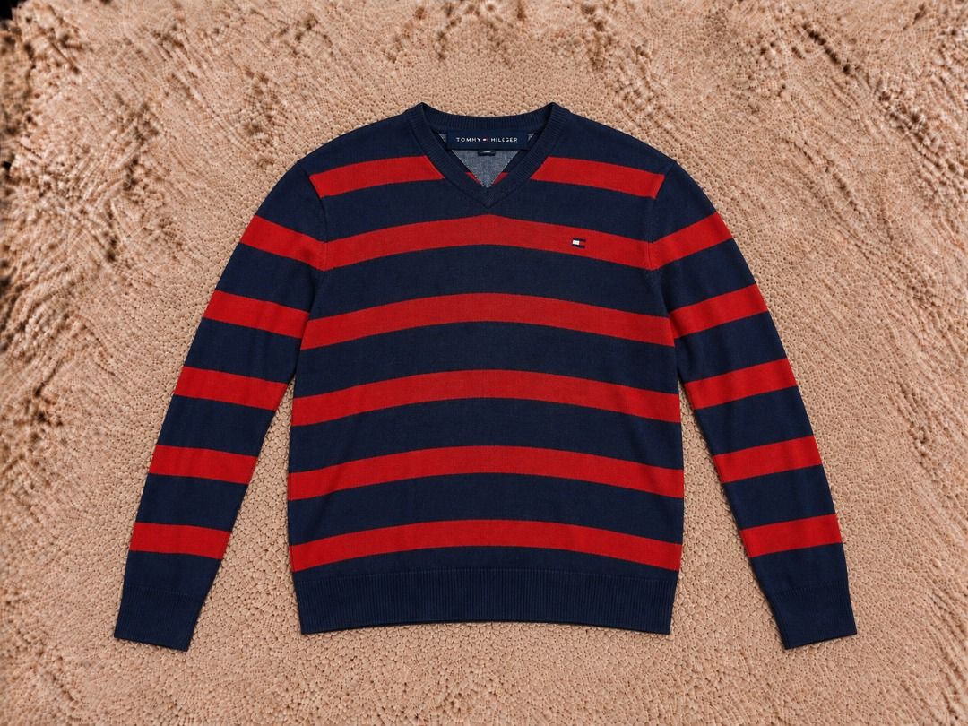 Tommy Hilfiger Striped V-Neck Sweater (Category: Coats, Jackets and Outerwear) located in Quezon City. Submitted by drift_and_vibe_thrift (Listing ID 1464873092, Image 1). Description: - Brand: Tommy Hilfiger - Style: V-neck sweater with navy blue & red horizontal stripes - Size: L - Material: 100% cotton (soft and comfortable) - Details: Long sleeves, ribbed hem, iconic embroidered flag logo on chest - Care: Machine washable - Condition: Excelle