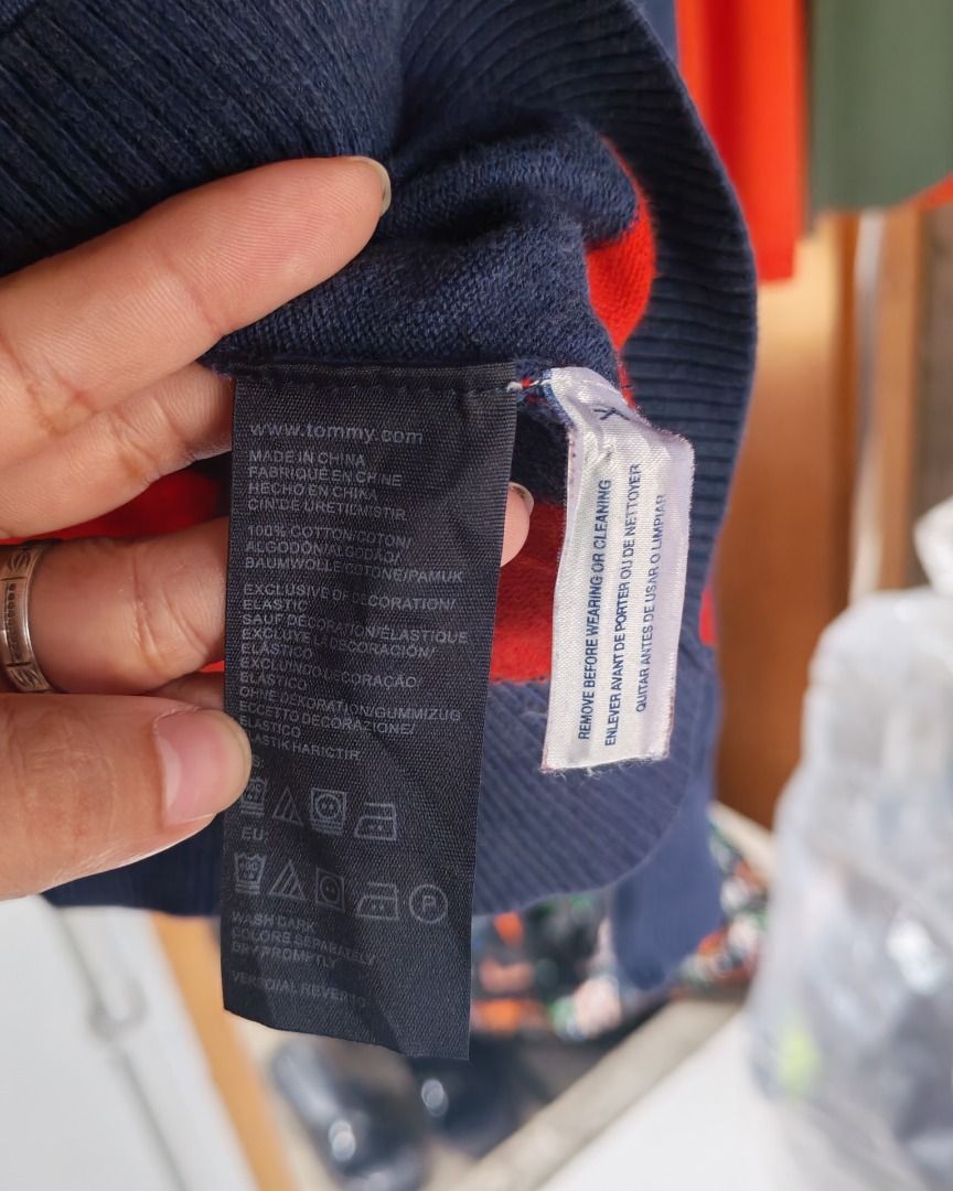 Tommy Hilfiger Striped V-Neck Sweater (Category: Coats, Jackets and Outerwear) located in Quezon City. Submitted by drift_and_vibe_thrift (Listing ID 1464873092, Image 3). Description: - Brand: Tommy Hilfiger - Style: V-neck sweater with navy blue & red horizontal stripes - Size: L - Material: 100% cotton (soft and comfortable) - Details: Long sleeves, ribbed hem, iconic embroidered flag logo on chest - Care: Machine washable - Condition: Excelle