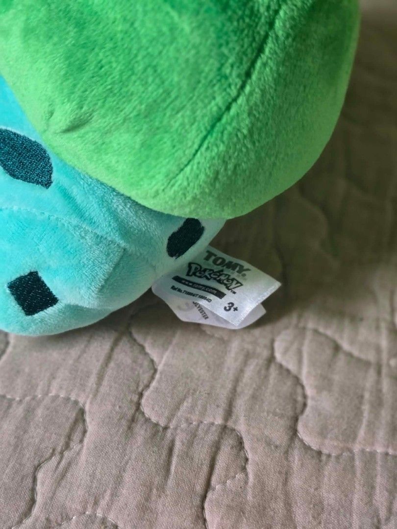 Tomy Pokémon Bulbasaur Plush Toy with Tags (Category: Plushies & Soft Toys) located in Baguio. Submitted by je_ver_lyn16 (Listing ID 1464846137, Image 3). Description: - Authentic Tomy Bulbasaur plush toy - Measures ~5.5 inches tall - Made with soft fabric, bright green bulb, and embroidered face/spots - Complete with original hang tag and side cloth tag - Perfect for Pokémon collectors and fans.