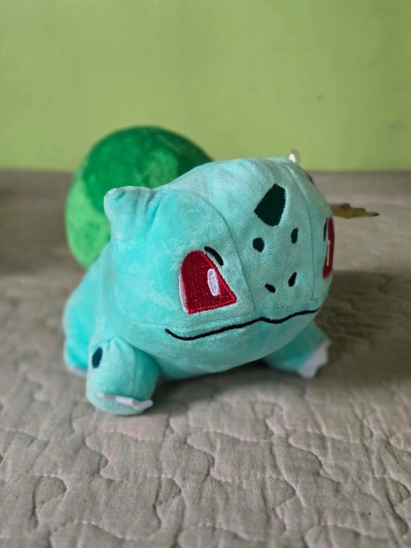 Tomy Pokémon Bulbasaur Plush Toy with Tags (Category: Plushies & Soft Toys) located in Baguio. Submitted by je_ver_lyn16 (Listing ID 1464846137, Image 1). Description: - Authentic Tomy Bulbasaur plush toy - Measures ~5.5 inches tall - Made with soft fabric, bright green bulb, and embroidered face/spots - Complete with original hang tag and side cloth tag - Perfect for Pokémon collectors and fans.