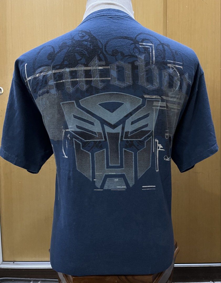 TRANSFORMERS (Category: Tshirts & Polo Shirts) located in Seremban. Submitted by imagurlilu (Listing ID 1464775556, Image 3). Description: ♥️TRANSFORMERS♥️ 🖤Size : Pit:22.5” / Lenght :28.5” 🖤 Tag : PRINTED GIANT ( Tag size L) 🖤 Made in : MEXICO 🖤 Fabric : 💯COTTON 🖤 Color : BLUE 🖤Stitch : DOUBLE ⬆️⬇️ 🖤 SIDEBONE : NO 🖤 Condition : 9/10 🖤 Defect / hole : ❌ 🖤 Graphic : STILL LOOK GOOD 🖤 Copyright / Trademark : 🚗 : COD SEREMBAN2 📝 : COLO