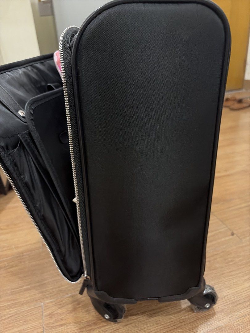 ParfoisTravel Edition Black Rolling Luggage Suitcase (Category: Luggage) located in Mandaluyong City. Submitted by iheartsokorpear (Listing ID 1464896867, Image 2). Description: - Model: Black Travel Edition Suitcase - Mobility: Smooth 360-degree wheels (protective plastic still attached) - Handle: Convenient telescoping handle - Storage: Wide-opening main compartment, front zippered pocket, and back zippered storage slot - Extras: Includes a mat