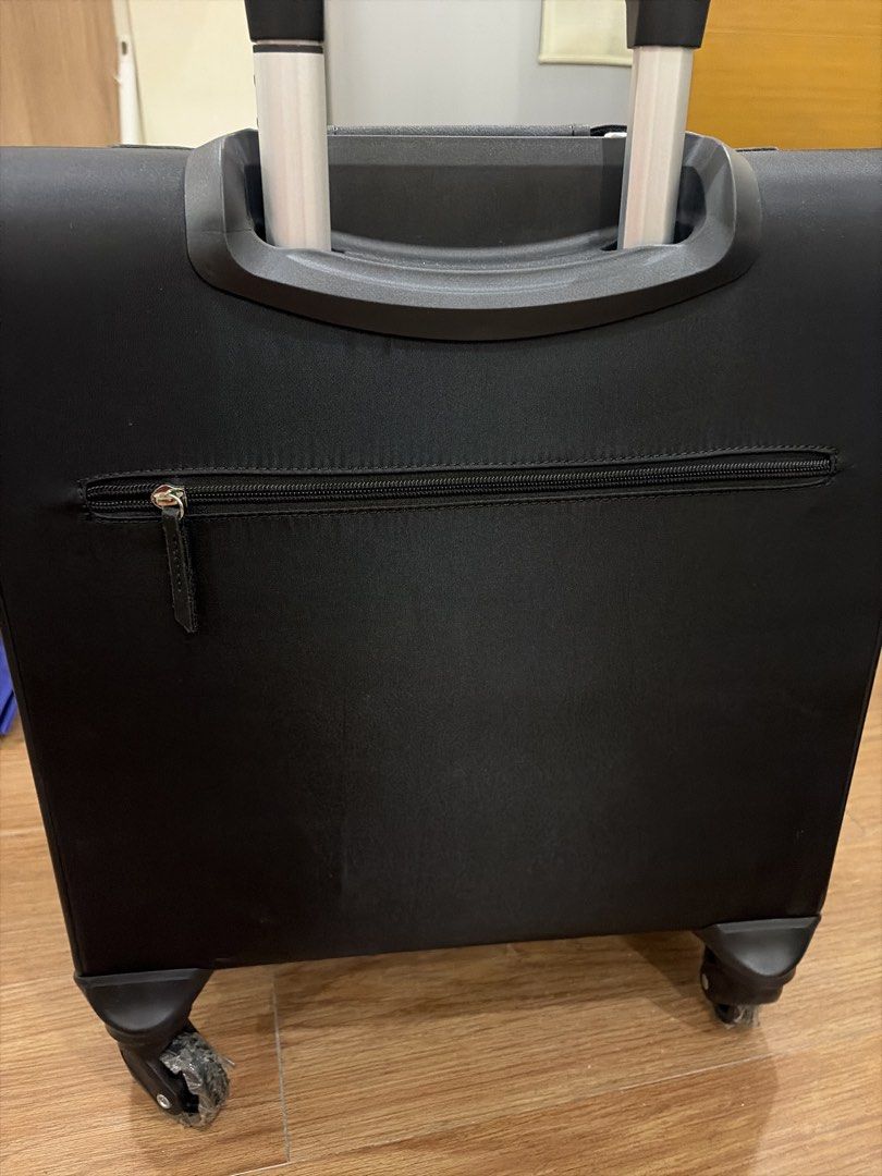 ParfoisTravel Edition Black Rolling Luggage Suitcase (Category: Luggage) located in Mandaluyong City. Submitted by iheartsokorpear (Listing ID 1464896867, Image 3). Description: - Model: Black Travel Edition Suitcase - Mobility: Smooth 360-degree wheels (protective plastic still attached) - Handle: Convenient telescoping handle - Storage: Wide-opening main compartment, front zippered pocket, and back zippered storage slot - Extras: Includes a mat