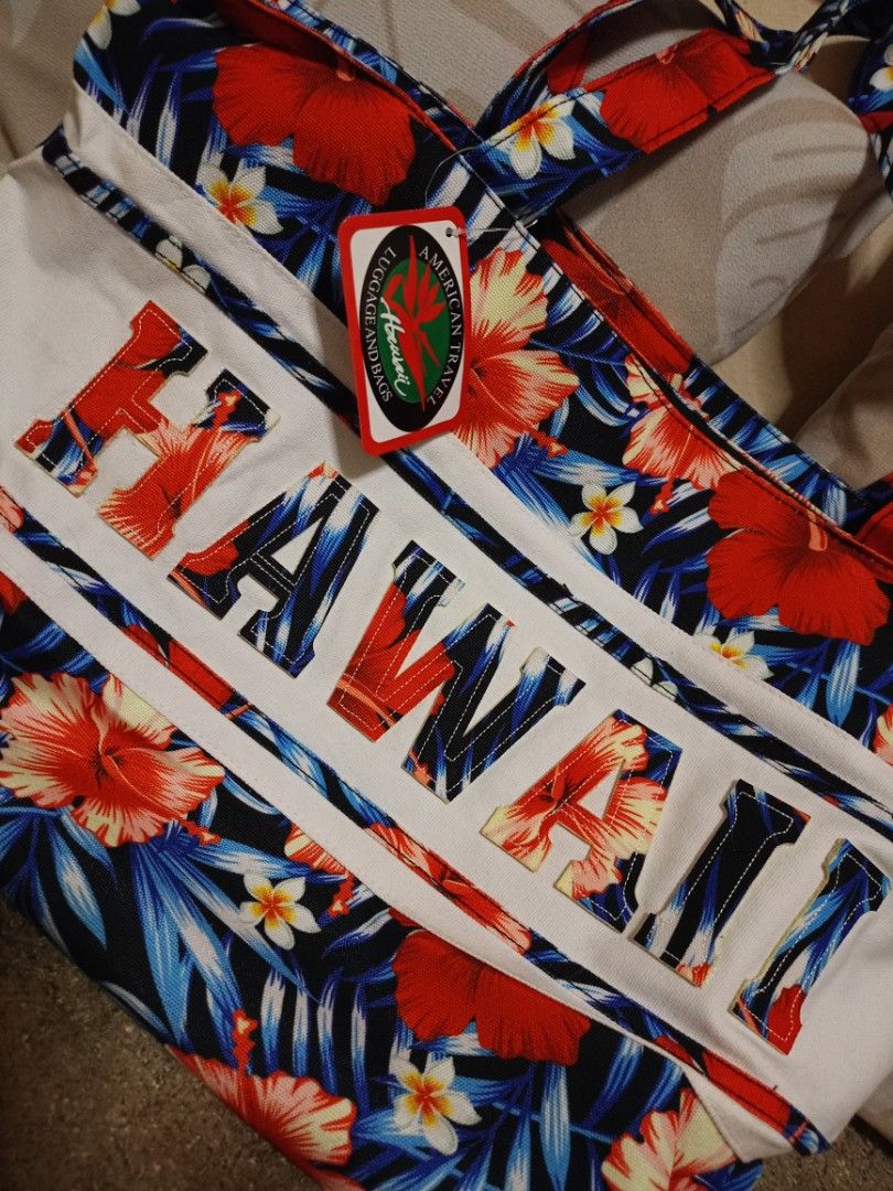 Tropical Floral Canvas Tote Bag (Category: Tote Bags) located in Valenzuela. Submitted by One.Only.Nan (Listing ID 1464923217, Image 2). Description: Get ready for your next vacation or beach day with this beautiful, brand-new Hawaii Tropical Floral Beach Tote Bag. It features a vibrant, colorful hibiscus print with a bold "HAWAII" text block across the front. Perfect for the pool, beach, cruises, or everyday summer shopping! • Condition: Brand N