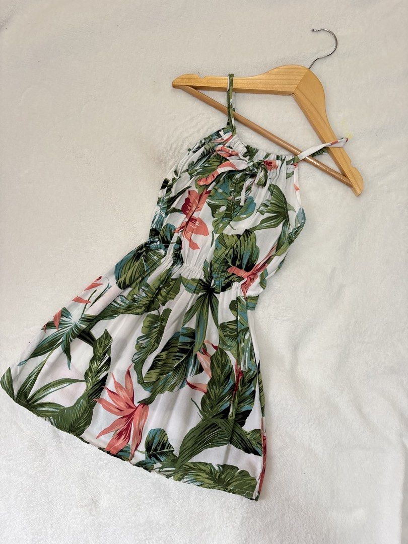 Tropical Leaf Print Halter Dress (Category: Babies & Kids Fashion) located in Cabuyao City. Submitted by mhd.i (Listing ID 1464968008, Image 1). Description: - 2-3y Tropical print dress with green leaves and pink floral accents on a white background. Halter neckline ties in a bow at the front. Elastic waistband creates a gathered fit through the middle. Lightweight fabric, great warm-weather outfit. Short length, very easy to throw on for vacatio