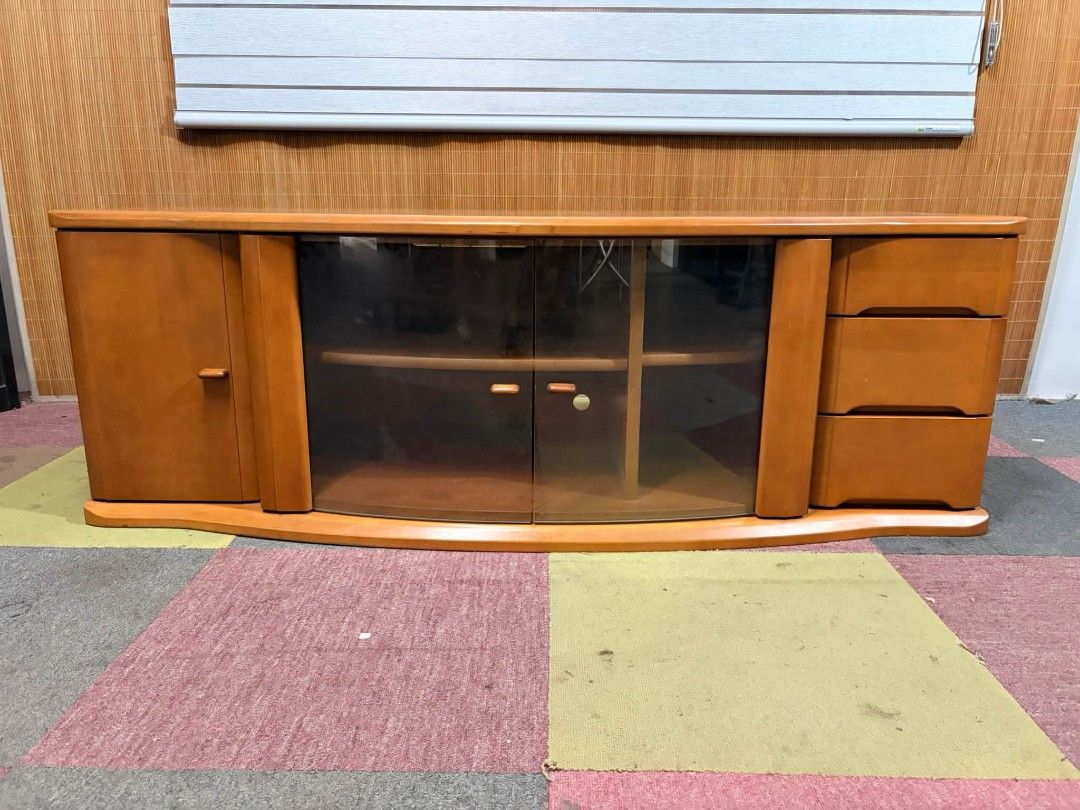 Tv Rack UpTo 65" (Category: TV Consoles) located in Meycauayan. Submitted by marygracecasimiro (Listing ID 1464822996, Image 1). Description: 😍SUPER SOLID WOOD!!! Elegant Curved Wooden Long Tv Rack CURVED GLASS!!! VERY HEAVY!!! ANGGANDA!!! UPTO 65-INCH TV!!! MAKINIS!!! This is a classic curved wooden TV stand featuring a central glass-paneled cabinet, a side cabinet, and three drawers on the right. Price : 11,900 ✅ *SEE VIDEO COMMENT 57L x 22W x