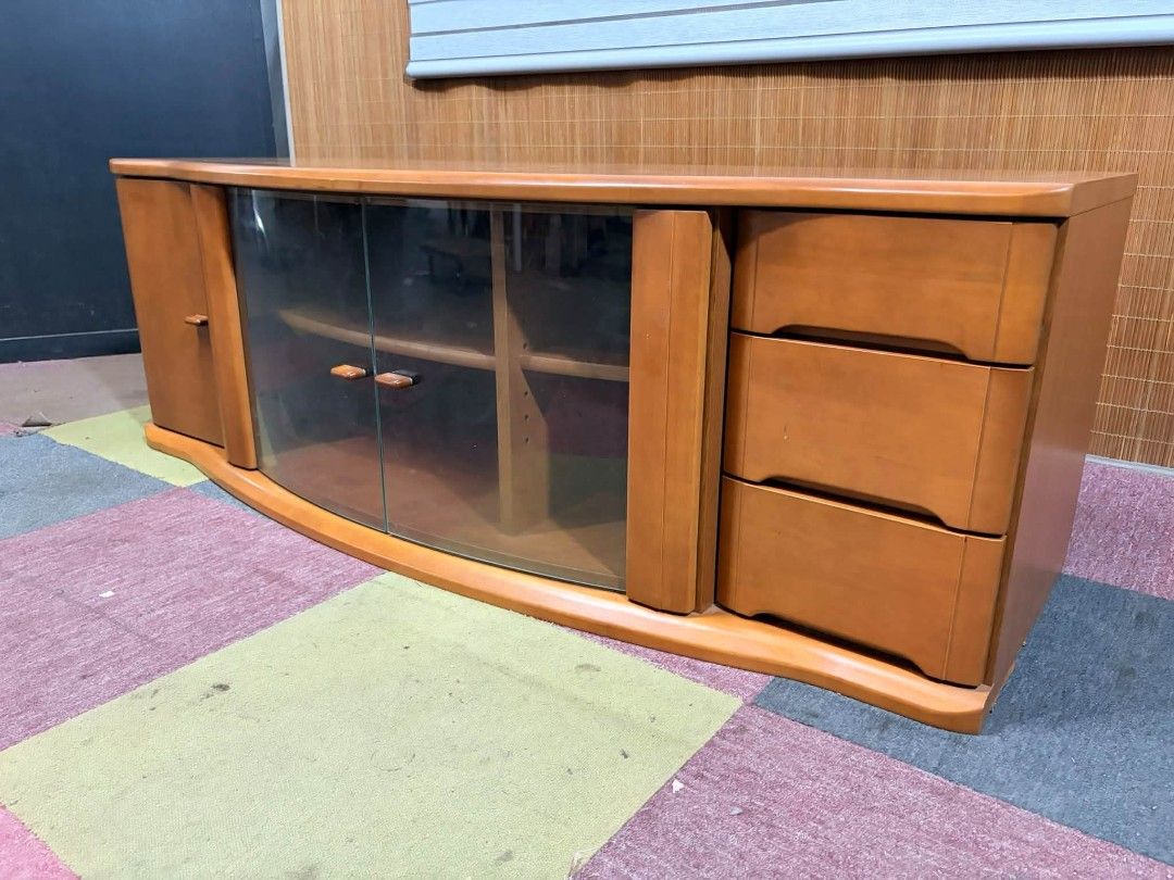 Tv Rack UpTo 65" (Category: TV Consoles) located in Meycauayan. Submitted by marygracecasimiro (Listing ID 1464822996, Image 3). Description: 😍SUPER SOLID WOOD!!! Elegant Curved Wooden Long Tv Rack CURVED GLASS!!! VERY HEAVY!!! ANGGANDA!!! UPTO 65-INCH TV!!! MAKINIS!!! This is a classic curved wooden TV stand featuring a central glass-paneled cabinet, a side cabinet, and three drawers on the right. Price : 11,900 ✅ *SEE VIDEO COMMENT 57L x 22W x