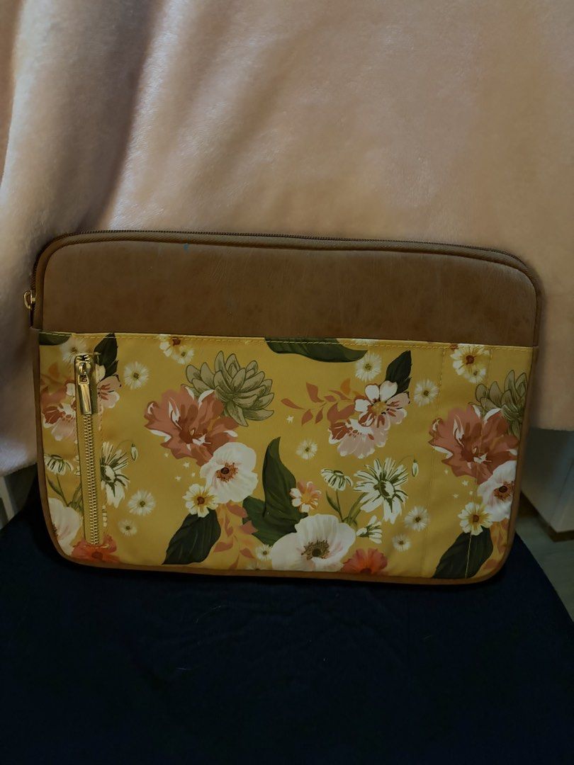 Typo 13 inch laptop case suedes (Category: Laptop Bags & Sleeves) located in Manila. Submitted by sc.moo04 (Listing ID 1464943200, Image 1). Description: - Design: Vibrant yellow floral print with stylish brown faux leather trim - Storage: Front zipper pocket with elegant gold hardware for accessories - Protection: Soft inner fabric to keep your device scratch-free - Compatibility: Fits standard notebooks and tablets securely - Condition: Clean e