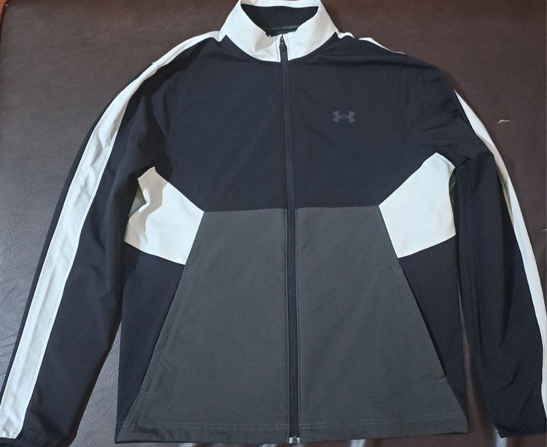 Under Armour Full-Zip Track Jacket Black Grey White (Category: Coats, Jackets and Outerwear) located in Manila. Submitted by yiponde89201 (Listing ID 1464845783, Image 1). Description: - Brand: Under Armour - Style: Full-zip track jacket - Color: Black and dark grey color block with white accents - Condition: Clean and never used, zippers work smoothly - Use: Ideal for workouts or casual streetwear or golf.