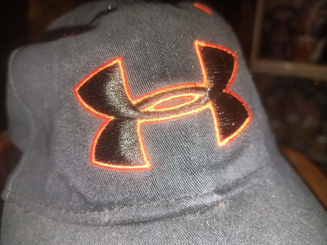 Under Armour Youth Cap Black Orange Logo (Category: Caps & Hats) located in Munoz. Submitted by larryc1212 (Listing ID 1464900529, Image 2). Description: - Brand: Under Armour - Color: Black with orange embroidered logo - Size: Youth Small/Medium - Material: Cotton and spandex blend for comfort and stretch - Fit: Structured fit with a curved brim - Details: Inner taped seams with printed Under Armour branding - Style Number: 1244660 (Spring 2014 