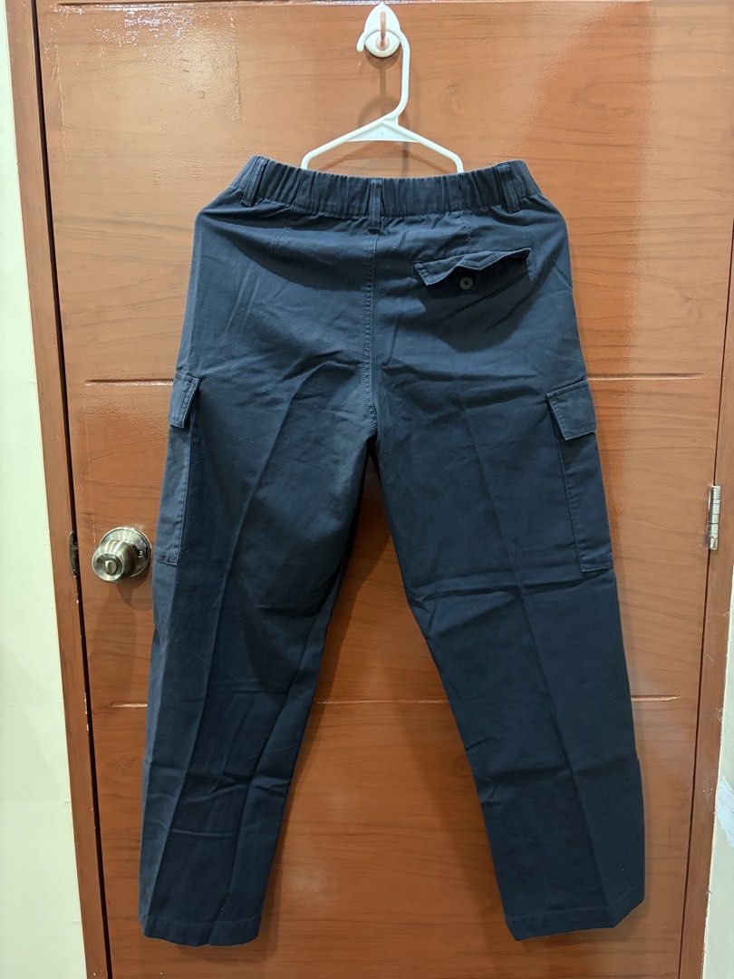 Uniqlo Cargo Pants Black Size S (Category: Other Bottoms) located in Manila. Submitted by carat.md (Listing ID 1464780689, Image 2). Description: - Brand: Uniqlo - Color: Black - Size: S (Fits waist 60-66cm, hip 85-91cm) - Material: 100% cotton body - Features: Utility pockets on both legs, back pocket with button closure, and elastic waistband at the back for extra comfort - Origin: Made in Cambodia.