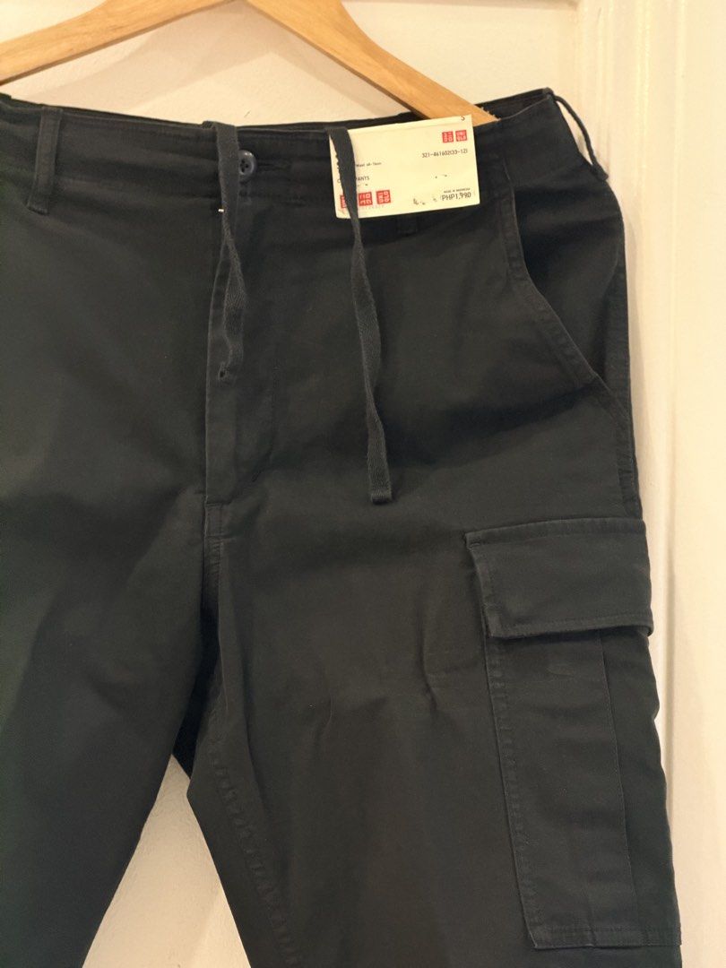 Uniqlo Cargo Pants Navy small (Category: Trousers) located in Quezon City. Submitted by q96wh2z4d9 (Listing ID 1464901084, Image 3). Description: - Brand: Uniqlo USED - Color: Dark Navy Blue - Style: Classic utility cargo pants with relaxed fit - Features: Side flap pockets and adjustable drawstring waist - Sizing: Refer to the attached tag for specific sizing details.