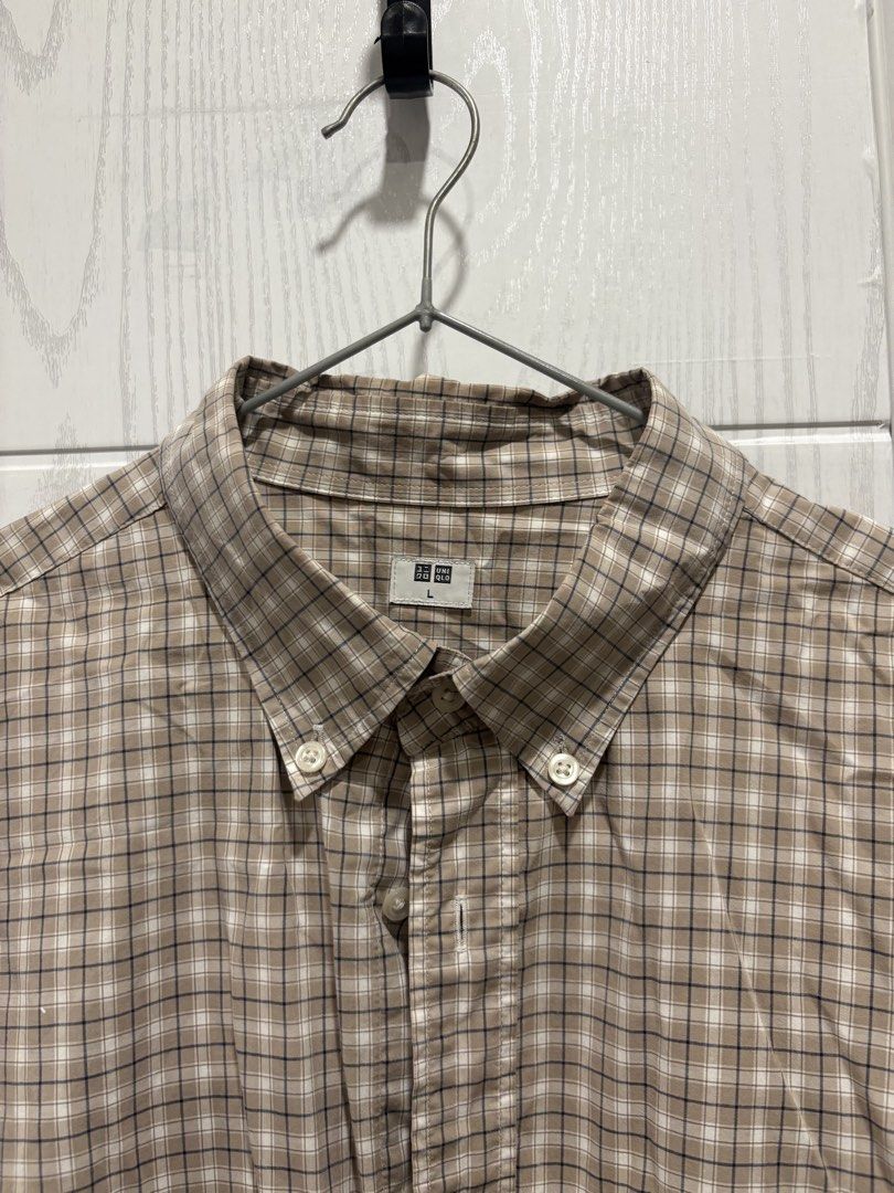 Uniqlo Plaid Button-Down Shirt Size L (Category: Tshirts & Polo Shirts ) located in Mandaluyong City. Submitted by shopwithjuu (Listing ID 1464781054, Image 2). Description: Uniqlo long sleeve plaid shirt in beige, white, and dark blue, size Large. Features a button-down collar, chest pocket, and adjustable cuffs. A versatile casual staple that pairs easily with jeans or chinos..