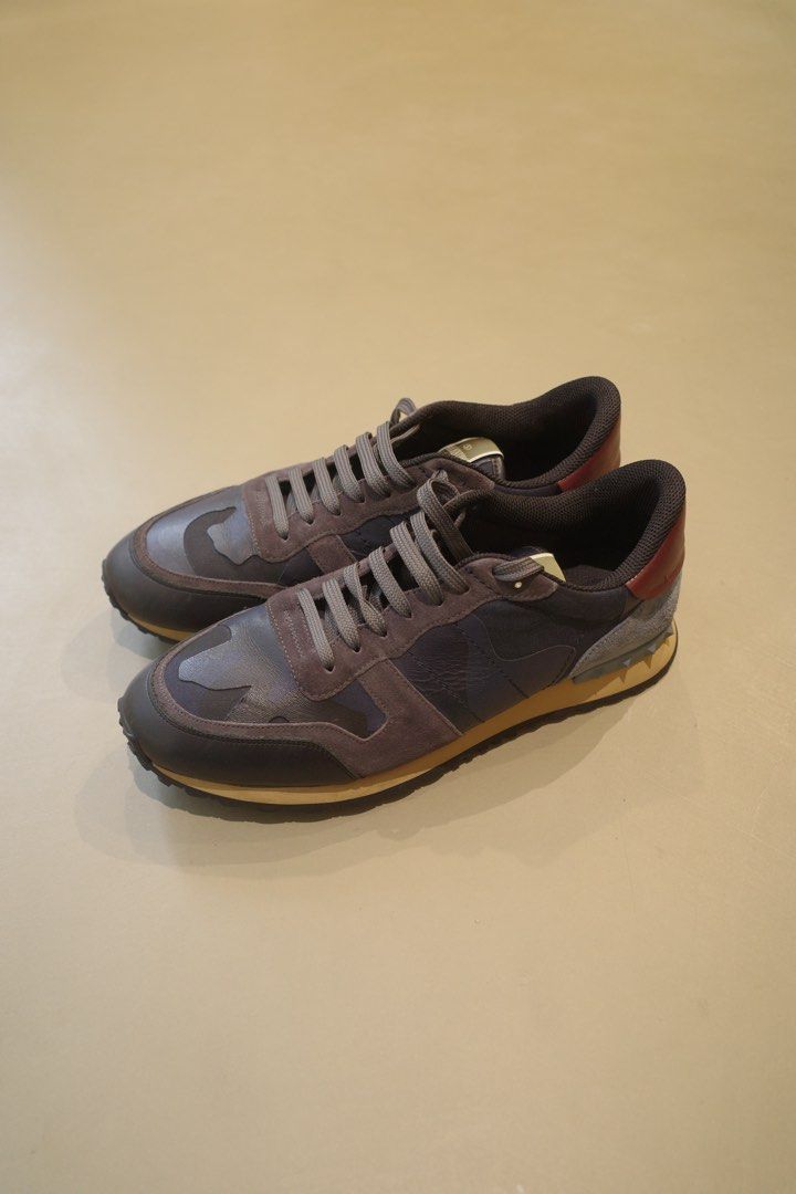 Valentino Garavani Rockrunner (Category: Casual Shoes) located in Pasig City. Submitted by rinse___repeat (Listing ID 1464906426, Image 1). Description: Valentino Garavani Rockrunner Seamlessly merging boldness with elegance, Valentino’s sleek approach to even the most casual of pieces ensures that you always look stylish, as seen in these navy blue Valentino Garavani Rockstud Rockrunner camouflage sneakers. Featuring a round toe, a lace-up front