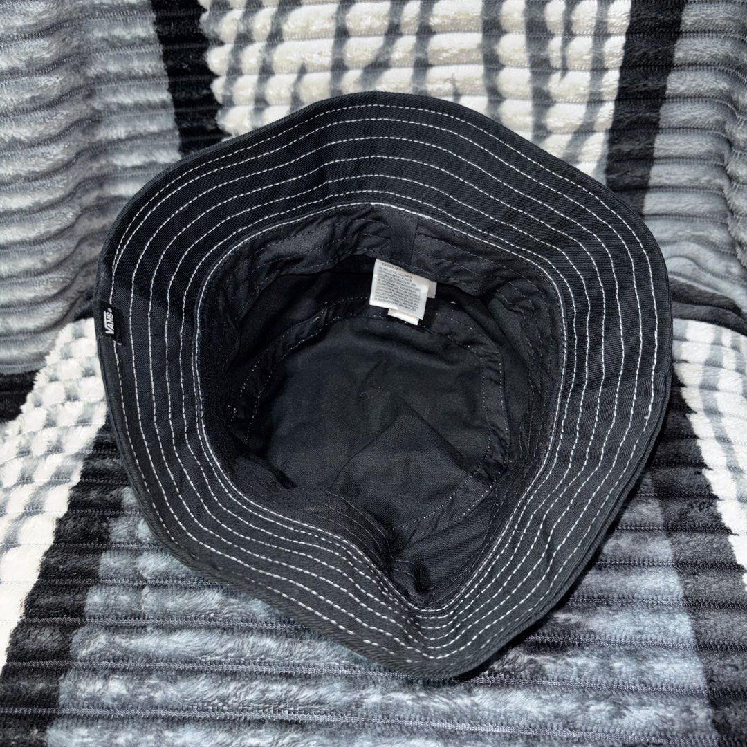 Vans Black Bucket Hat with White Contrast Stitching (Category: Caps & Hats) located in Iligan City. Submitted by 9200rsnl (Listing ID 1464798324, Image 3). Description: - Brand: Vans - Color: Classic black with white contrast stitching - Material: 100% cotton (Made in Bangladesh) - Features: Embroidered white Vans logo on the front and side woven tag - Perfect for: Casual streetwear, sunny days, and everyday styling.