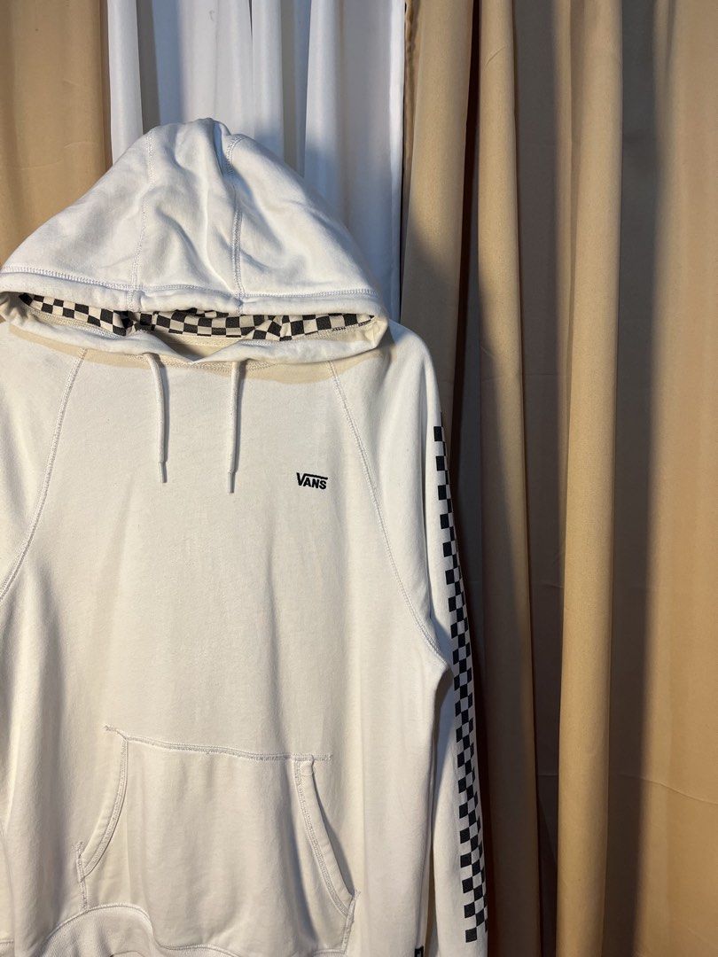 Vans Checkerboard Hoodie White Size Medium (Category: Hoodies) located in Kidapawan. Submitted by azythrift (Listing ID 1464914727, Image 2). Description: - Authentic White Vans hoodie - Size: Medium (based on inner neck tag) - Iconic black and white checkerboard print on sleeves and hood lining - Small black embroidered Vans logo on the left chest - Cozy fleece interior for maximum comfort - Features a front kangaroo pocket and drawstring hood -