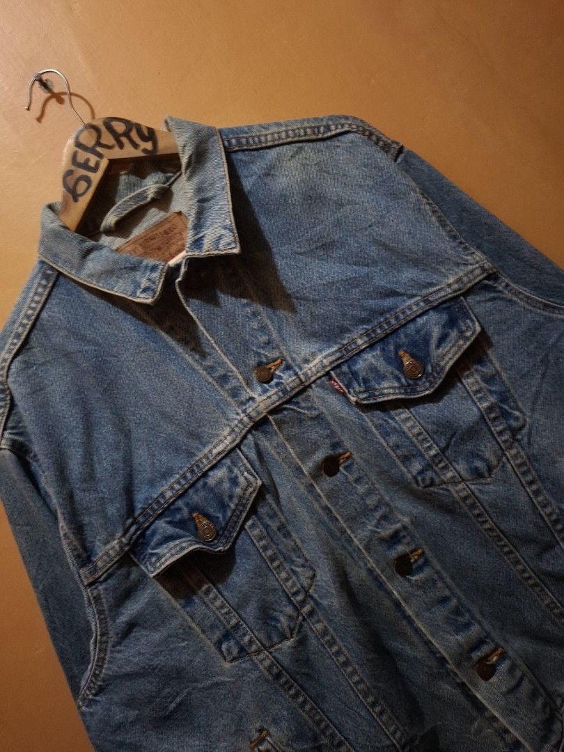 Vintage 1996 Levi's Washed Trucker Jacket (Category: Coats, Jackets and Outerwear) located in Manila. Submitted by bonaobrag55538 (Listing ID 1464844315, Image 2). Description: - Vintage 1996 Levi's washed trucker jacket, proudly Made in USA - Classic mid-blue wash with traditional metal shank buttons - Features dual chest pockets with red tab and convenient side pockets - Authentic leather patch at the back collar - Measurements: 24 inches pit t