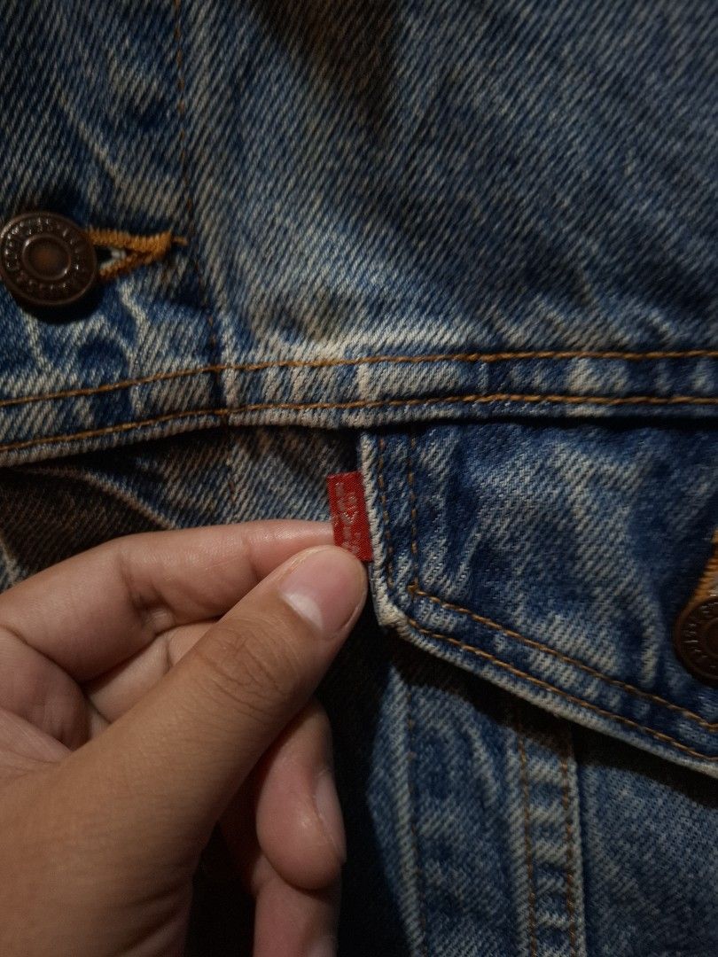Vintage 1996 Levi's Washed Trucker Jacket (Category: Coats, Jackets and Outerwear) located in Manila. Submitted by bonaobrag55538 (Listing ID 1464844315, Image 3). Description: - Vintage 1996 Levi's washed trucker jacket, proudly Made in USA - Classic mid-blue wash with traditional metal shank buttons - Features dual chest pockets with red tab and convenient side pockets - Authentic leather patch at the back collar - Measurements: 24 inches pit t