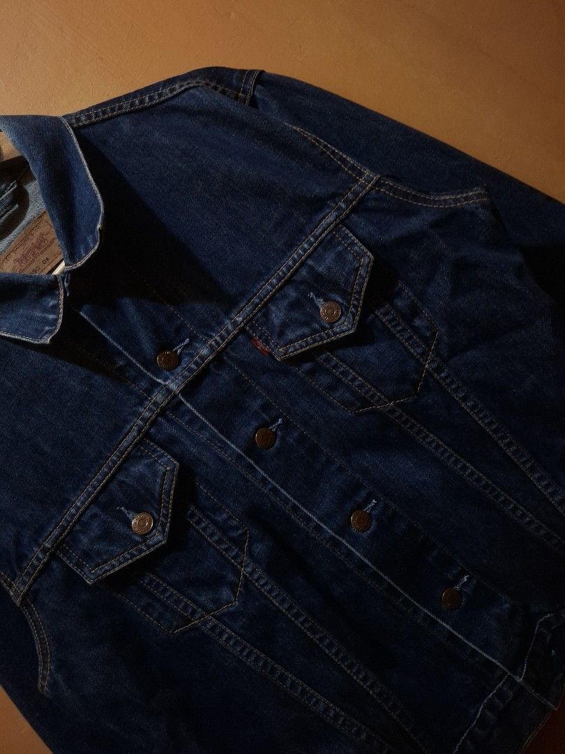 Vintage 2002 Levi's Type 3 Trucker Jacket (Category: Coats, Jackets and Outerwear) located in Manila. Submitted by bonaobrag55538 (Listing ID 1464843594, Image 3). Description: - Brand: Levi's - Style: Vintage 2002 Type 3 Denim Jacket - Wash: Dark wash - Size: XL but fit to medium - Measurements: 21 inches across the chest, 25.5 inches in length - Details: Classic button-up front, dual chest pockets, iconic red tab - Condition: Excellent vintage 