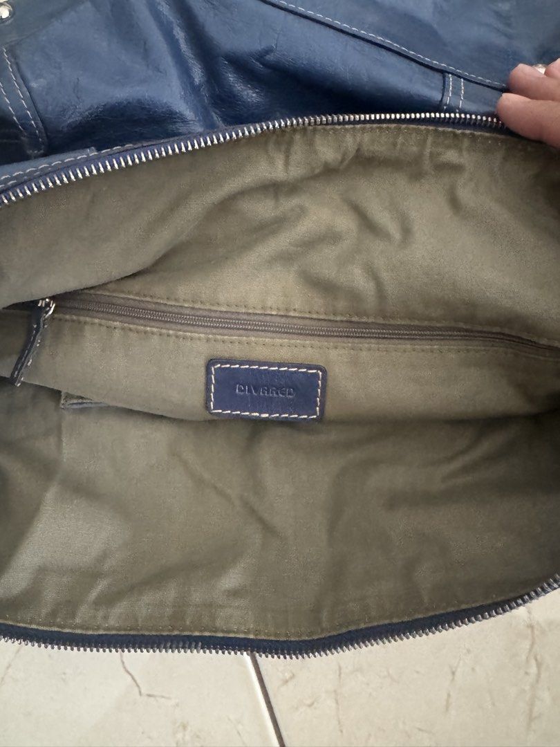 Vintage Blue Leather Shoulder Bag w/ Strap (Category: Shoulder Bags) located in Makati City. Submitted by lumpiawrapper (Listing ID 1464821472, Image 3). Description: - Brand: DIVABED - Color: Blue - Material: Leather - Carrying Options: Double carry handles + long strap - Pockets: Multiple exterior zippered pockets, interior slip pockets, and an inner zip pocket - Closure: Main zip closure - Extra Features: Metal hardware and 4 bottom protective