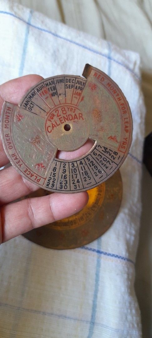 Vintage Brass Perpetual Calendar Disc Wheel (Category: Vintage Collectibles) located in Bocaue. Submitted by marajapansurplus (Listing ID 1464777940, Image 3). Description: - Vintage circular perpetual calendar crafted from solid brass - Selling as it is - Features two rotating metal discs for months, dates, and years (1980s to 2000s) - Beautiful aged look with authentic patina, oxidation spots, and surface wear - Ideal as a retro desk accessory,