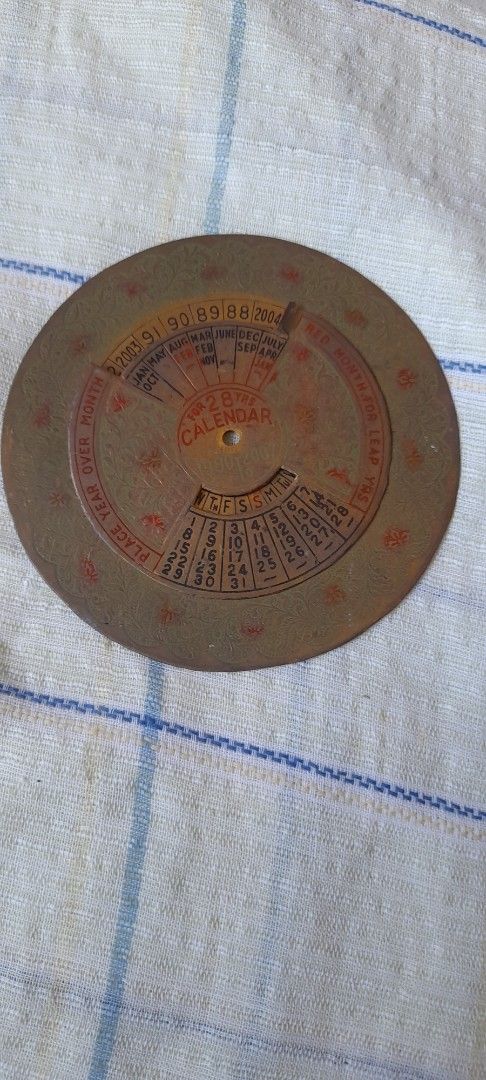 Vintage Brass Perpetual Calendar Disc Wheel (Category: Vintage Collectibles) located in Bocaue. Submitted by marajapansurplus (Listing ID 1464777940, Image 1). Description: - Vintage circular perpetual calendar crafted from solid brass - Selling as it is - Features two rotating metal discs for months, dates, and years (1980s to 2000s) - Beautiful aged look with authentic patina, oxidation spots, and surface wear - Ideal as a retro desk accessory,