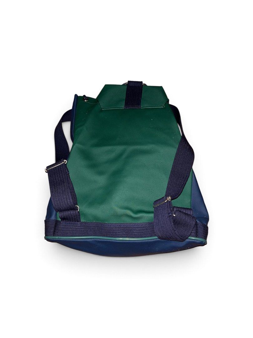 Vintage Chemise Lacoste Backpack (Category: Backpacks) located in Nabua. Submitted by lastthrift2.0 (Listing ID 1464960284, Image 2). Description: Issue•Check last photo Plus sf - Vintage Chemise Lacoste colorblock backpack (navy, green, and red) - Large debossed crocodile logo on the front pocket - Secure drawstring main closure under a buckled flap - Durable adjustable canvas shoulder straps - Classic Chemise Lacoste interior branding tag - Rar