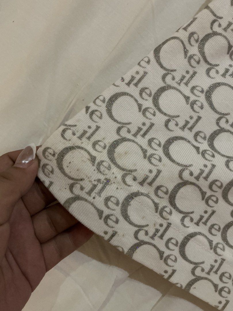 vintage gem top (Category: Others Tops) located in Ozamiz City. Submitted by el.dmn (Listing ID 1464815940, Image 3). Description: White with silver glitter vintage monogram print top Eye-catching front rhinestone graphic and small metal logo plate Stretchy fabric with an easy pull-on style has a stain kinda but can be removed naman. some beads/rhinestones are missing but not too obvious when worn. it has no size but it probably fits M-L best! ca