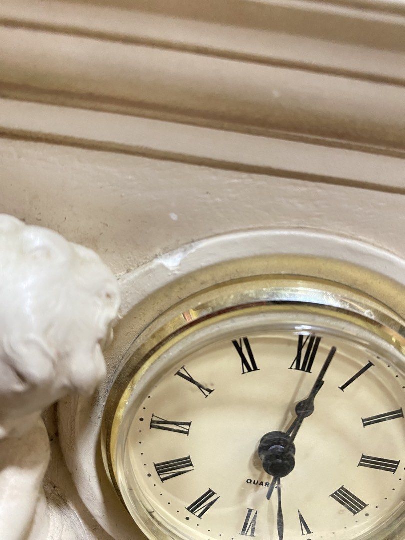Vintage Neoclassical Table Clock Cherub Mantle Clock (Category: Clocks) located in Calamba. Submitted by chebvintagedepot (Listing ID 1464806735, Image 3). Description: [B24-02] This Cherub Mantle Clock has a neoclassical design inspired by the architecture and decorative style of the French chateau at Versailles. It features twin cherub figures beside the clock, giving it the look of a decorative architectural sculpture. It is battery-operated a