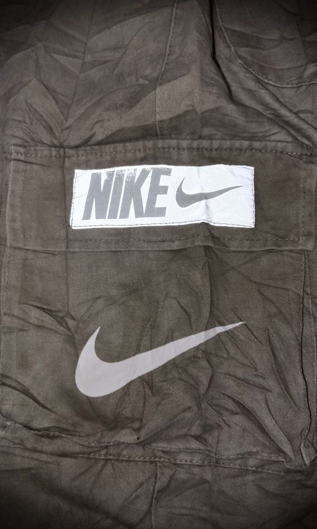 Vintage Nike Red Tag Cargo Pants (Category: Jeans) located in Manila. Submitted by liliaplay (Listing ID 1464797127, Image 3). Description: Authentic! Pre-loved Imported 7 pockets solid print designs reflectorized patch design strap pockets semi heavy and thick Unisex for teenagers or small adults 4flat below size: 24-26 hem/rise: 10.5 length: 32.5 No Issue! need wash Lowered to its negotiable price Payment 1st Shipped.