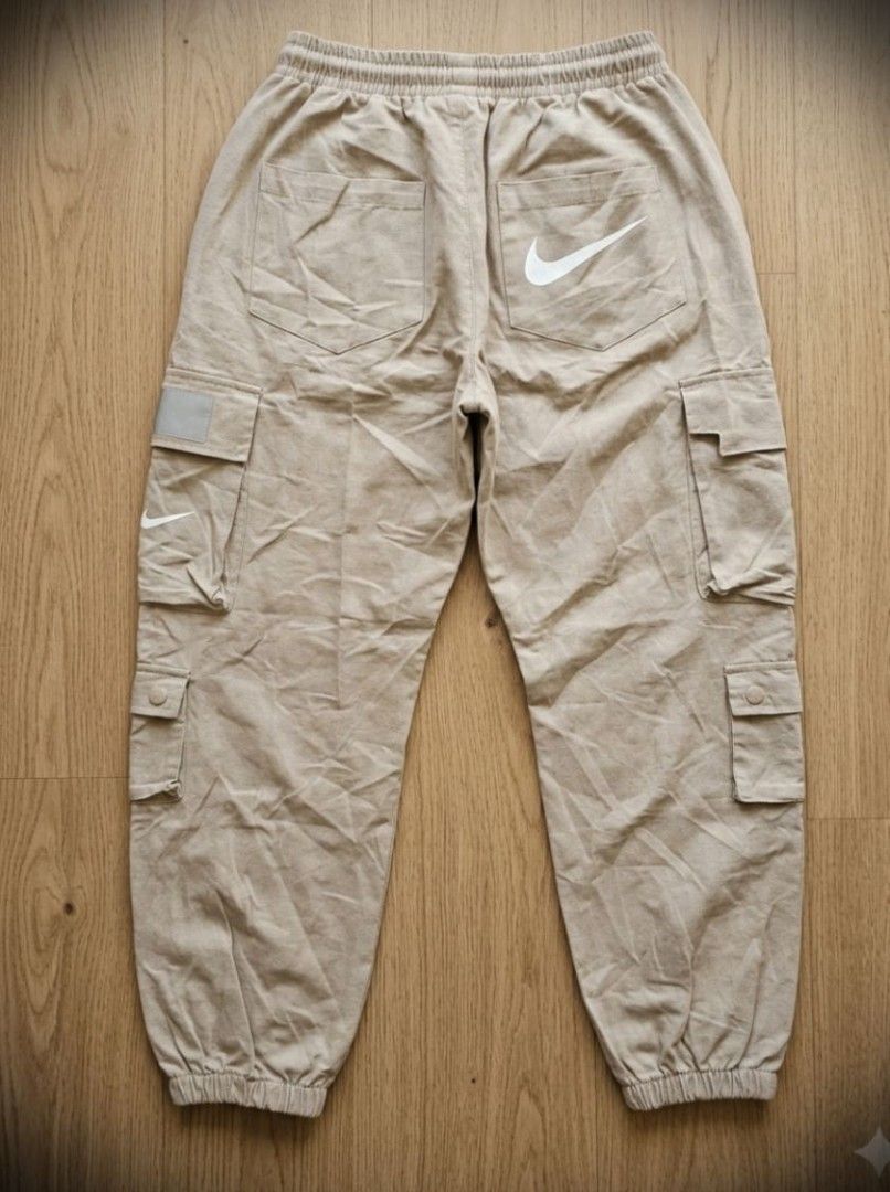 Vintage Nike Red Tag Cargo Pants (Category: Jeans) located in Manila. Submitted by liliaplay (Listing ID 1464797127, Image 2). Description: Authentic! Pre-loved Imported 7 pockets solid print designs reflectorized patch design strap pockets semi heavy and thick Unisex for teenagers or small adults 4flat below size: 24-26 hem/rise: 10.5 length: 32.5 No Issue! need wash Lowered to its negotiable price Payment 1st Shipped.