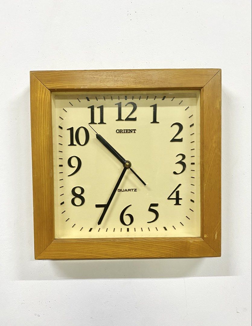 Vintage Orient Wooden Square Wall Clock (Category: Clocks) located in Santa Rosa. Submitted by annie_annie83 (Listing ID 1464874050, Image 1). Description: - Brand: Orient - Type: Square wooden wall clock - Movement: Quartz (battery-operated) - Design: Off-white face with classic black Arabic numerals - Unique feature: Japanese kanji inscription stamped on the wooden side panel - Condition: Wooden frame shows minor surface wear from previous hang