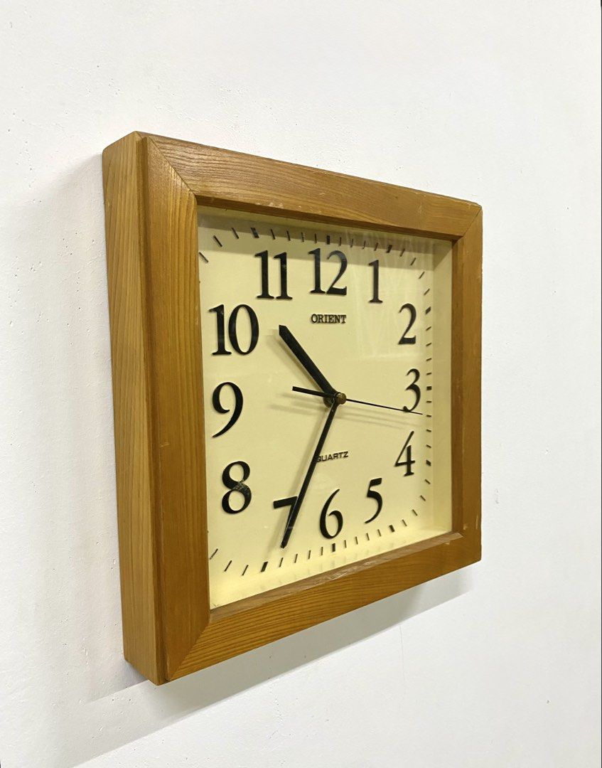 Vintage Orient Wooden Square Wall Clock (Category: Clocks) located in Santa Rosa. Submitted by annie_annie83 (Listing ID 1464874050, Image 3). Description: - Brand: Orient - Type: Square wooden wall clock - Movement: Quartz (battery-operated) - Design: Off-white face with classic black Arabic numerals - Unique feature: Japanese kanji inscription stamped on the wooden side panel - Condition: Wooden frame shows minor surface wear from previous hang
