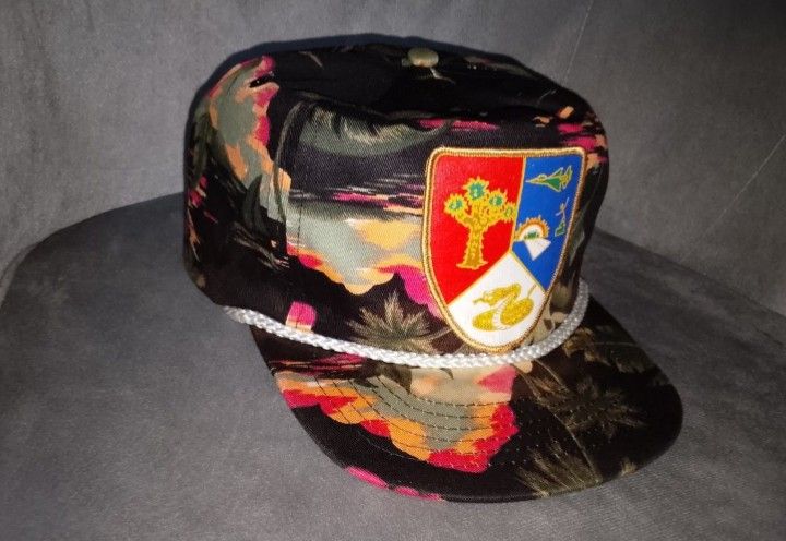 Vintage SAN SUN Black Tropical Sunset & Shield Patch Snapback Hat (Category: Caps & Hats) located in Binangonan. Submitted by yuristalin888 (Listing ID 1464780950, Image 3). Description: Add a unique, retro statement piece to your wardrobe with this vintage SAN SUN snapback hat. It features an all-over tropical sunset and palm tree pattern in shades of black, pink, orange, and green. The front is highlighted by a distinctive multi-colored embroid