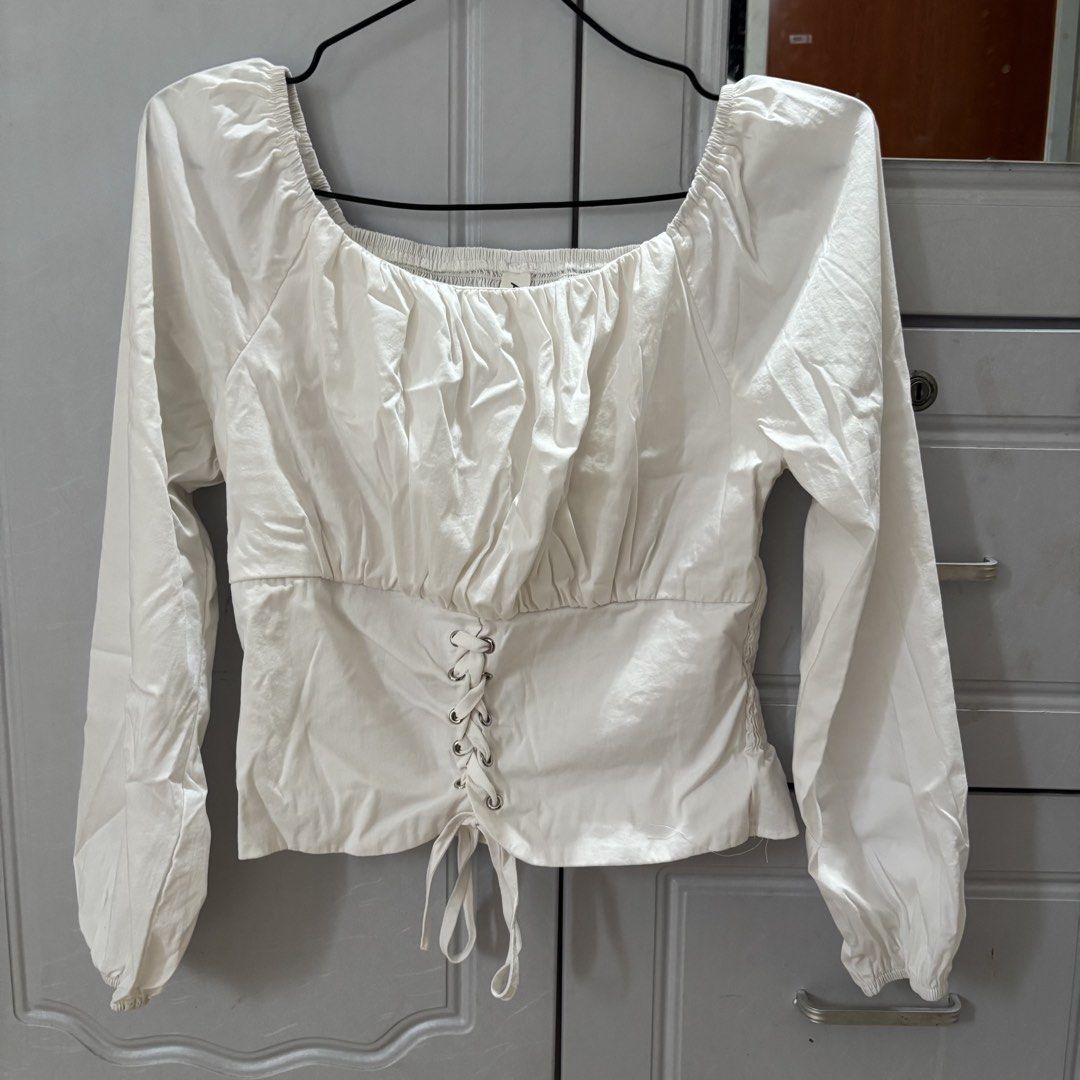Vintage White Bustier Corset Puff (Category: Longsleeves) located in Binan City. Submitted by myprelovedhaul (Listing ID 1464925679, Image 2). Description: This chic white milkmaid blouse features an eye-catching front lace-up corset detail and a classic square neckline..