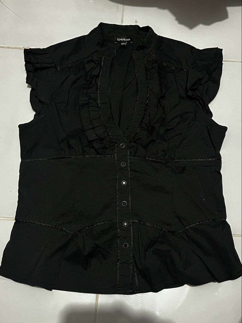 Vintage Y2K Goth bebe black button-up blouse (Category: Blouses) located in Paranaque City. Submitted by flees.thrift10 (Listing ID 1464901164, Image 1). Description: It features a plunging V-neckline framed with tiered ruffle trim, a structured panel waist, and short cap ruffle sleeves..