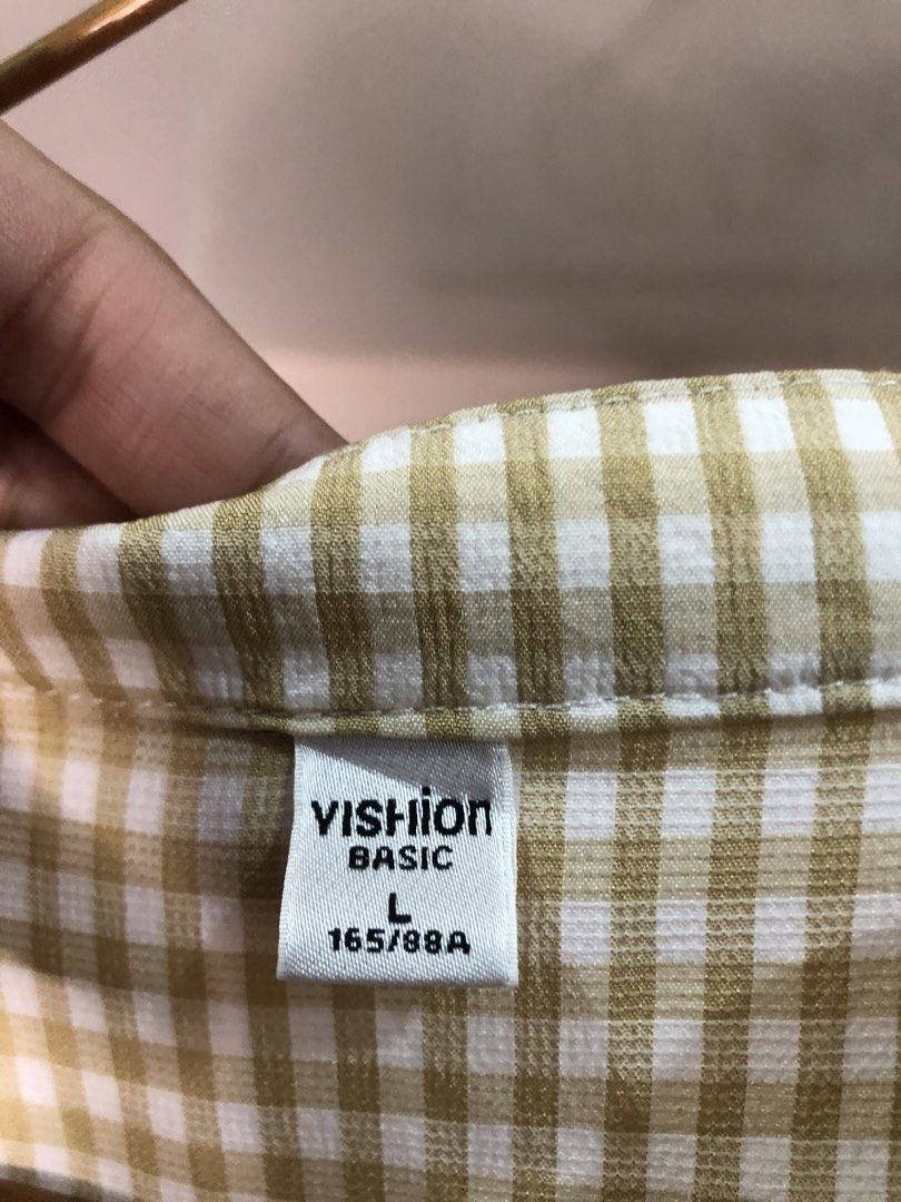 VISHION BASIC Beige Gingham Button-Up Blouse Size L (Category: Blouses) located in Cauayan City . Submitted by wholly.craaaft (Listing ID 1464946329, Image 2). Description: - Brand/Style: VISHION BASIC gingham check button-up blouse - Color: Beige and white - Size: L (Tagged 165/88A) - Design: Mandarin collar, front button placket, short sleeves with folded cuffs, relaxed fit - Condition: Clean inside and out, well-kept.
