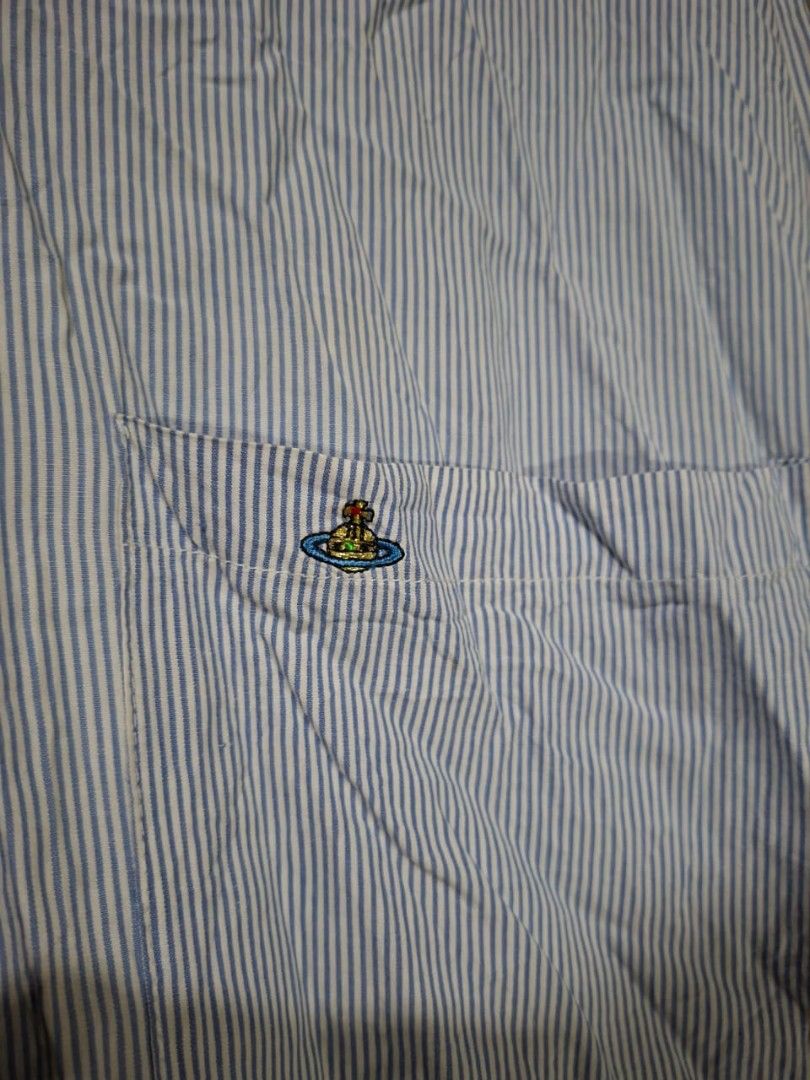 Vivienne Westwood (Category: Blouses) located in Leyte. Submitted by jpsrvd19 (Listing ID 1464904184, Image 2). Description: - Vivienne Westwood London button-up shirt - Classic blue and white stripe pattern - Long sleeves with convenient tab rolls - Features a single chest pocket with embroidered orb logo detail - Brown front button closure - Cut washtag.