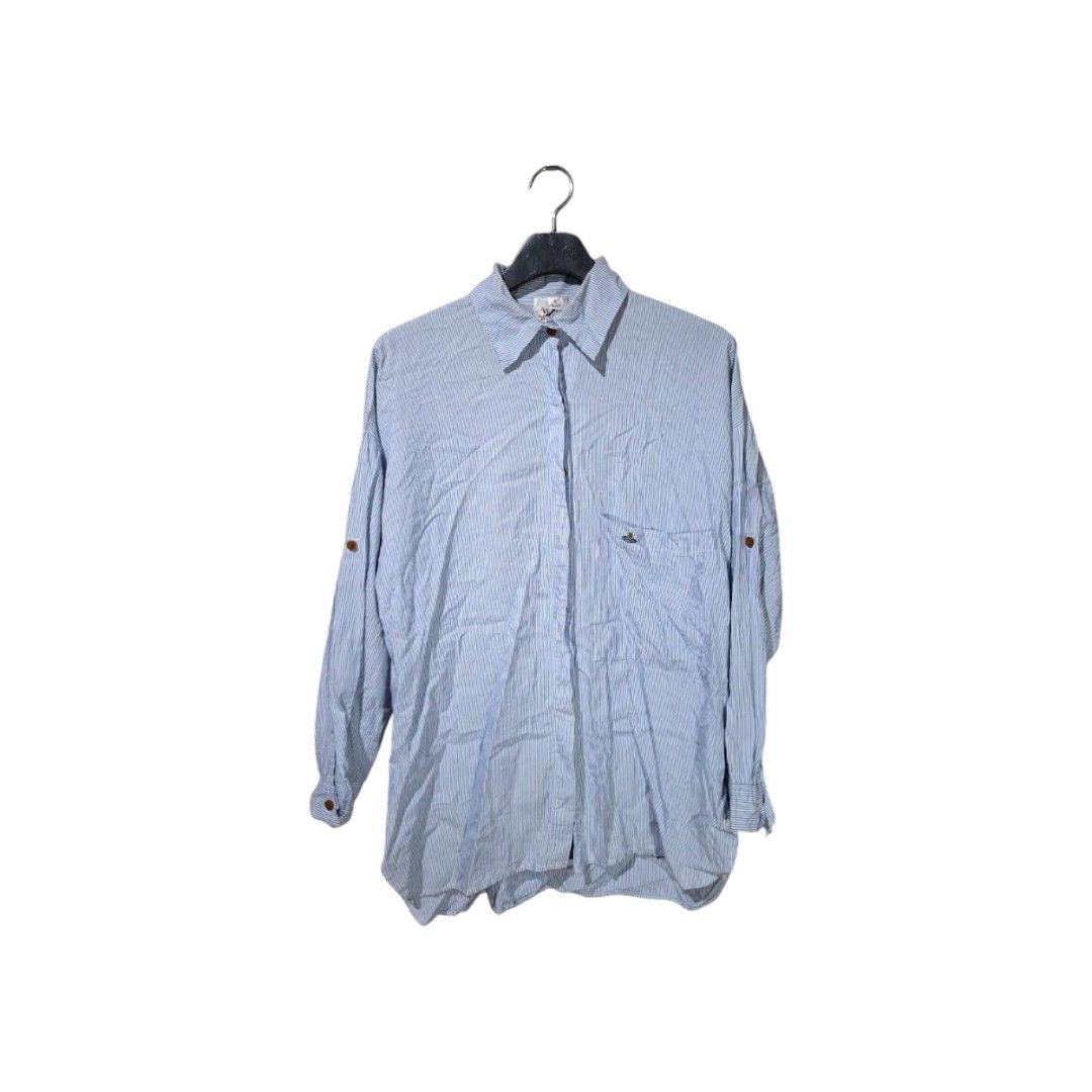 Vivienne Westwood (Category: Blouses) located in San Juan (Cabalian). Submitted by ec8thrift (Listing ID 1464904362, Image 1). Description: - Vivienne Westwood London button-up shirt - Classic blue and white stripe pattern - Long sleeves with convenient tab rolls - Features a single chest pocket with embroidered orb logo detail - Brown front button closure - Cut washtag.