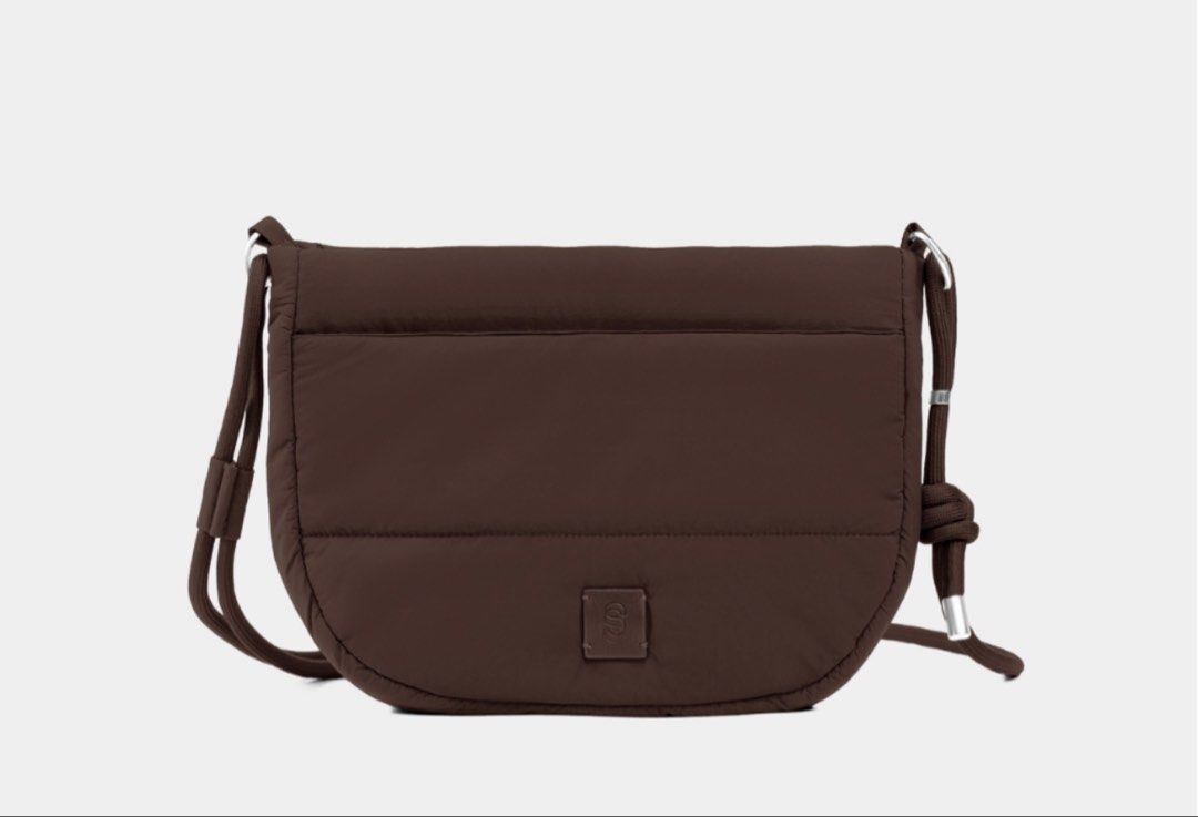 Wanda sling Puffed Crossbody Bag (Category: Cross-body Bags) located in Cavite. Submitted by nikkatsu (Listing ID 1464838097, Image 1). Description: - Trendy puffed nylon crossbody bag available in brown and black - Secure flap closure with clean tonal stitching and a square branded logo patch - Comfortable, adjustable rope strap accented with chic metal hardware - Ultra-lightweight and minimalist silhouette - Ideal everyday bag for your daily es