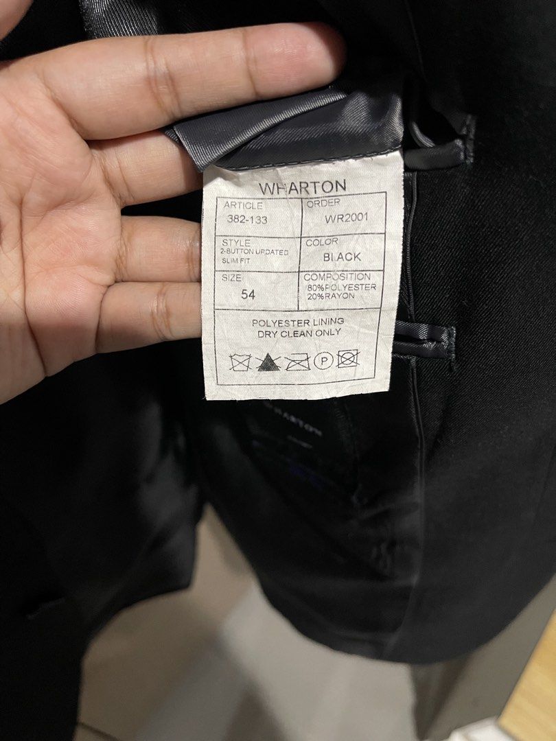 WHARTON |Two Button Suit Jacket | Black | Size 54 (Category: Coats, Jackets and Outerwear) located in Taguig. Submitted by shennelaluuh (Listing ID 1464835396, Image 3). Description: - Brand/Style: Wharton slim-fit blazer in solid black - Size: 54 - Material: 80% polyester, 20% rayon (polyester lining) - Closure: Two-button front - Pockets: Chest pocket and hip flap pockets - Cuffs: Three buttons on each cuff - Care: Dry clean only.