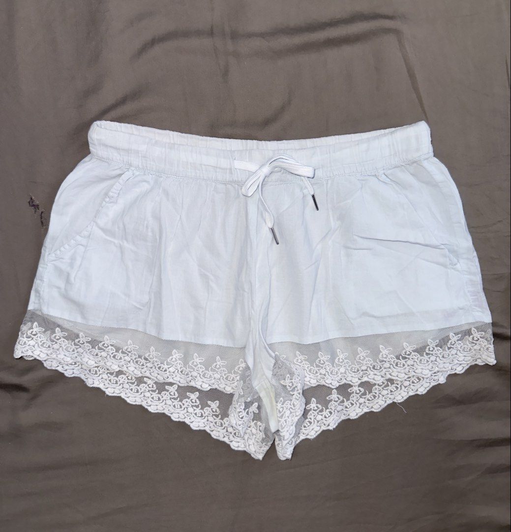 White lace trim drawstring shorts size M (Category: Shorts) located in Santa Ana. Submitted by fatikilla (Listing ID 1464818617, Image 1). Description: - Color: White - Size: M (tag attached) - Material: 100% polyester - Details: Cute lace trim at the hem, comfortable elastic waistband with matching white drawstring - Origin: Made in Cambodia - Condition: Brand new with tags.