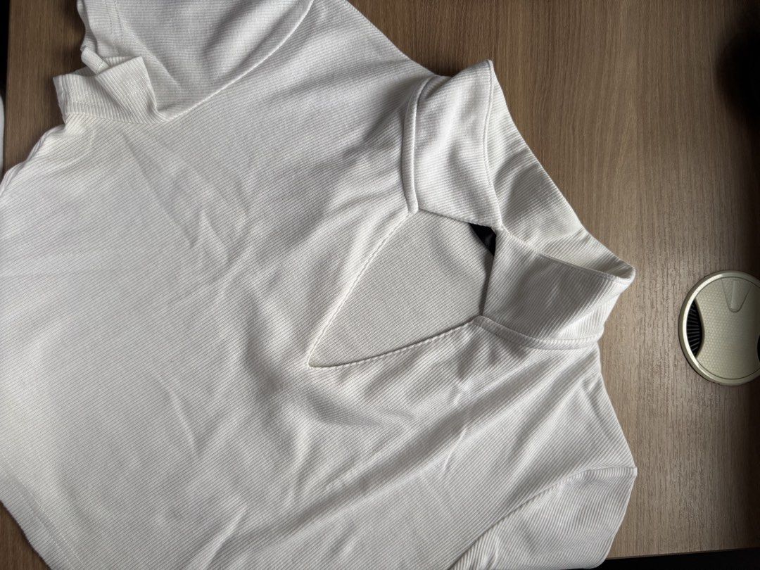 White ribbed crop top with v-neck collar (Category: Sleeveless) located in Rizal. Submitted by yowfaveariesdeclutter (Listing ID 1464867720, Image 2). Description: - Color: White - Material: Stretchy ribbed knit fabric for ultimate comfort - Design: Short sleeves, mock neck, and trendy deep V-cut neckline cutout - Fit: True to size, flattering crop top length - Styling: Great basic piece; easily pairs with high-waisted jeans or skirts for a daily