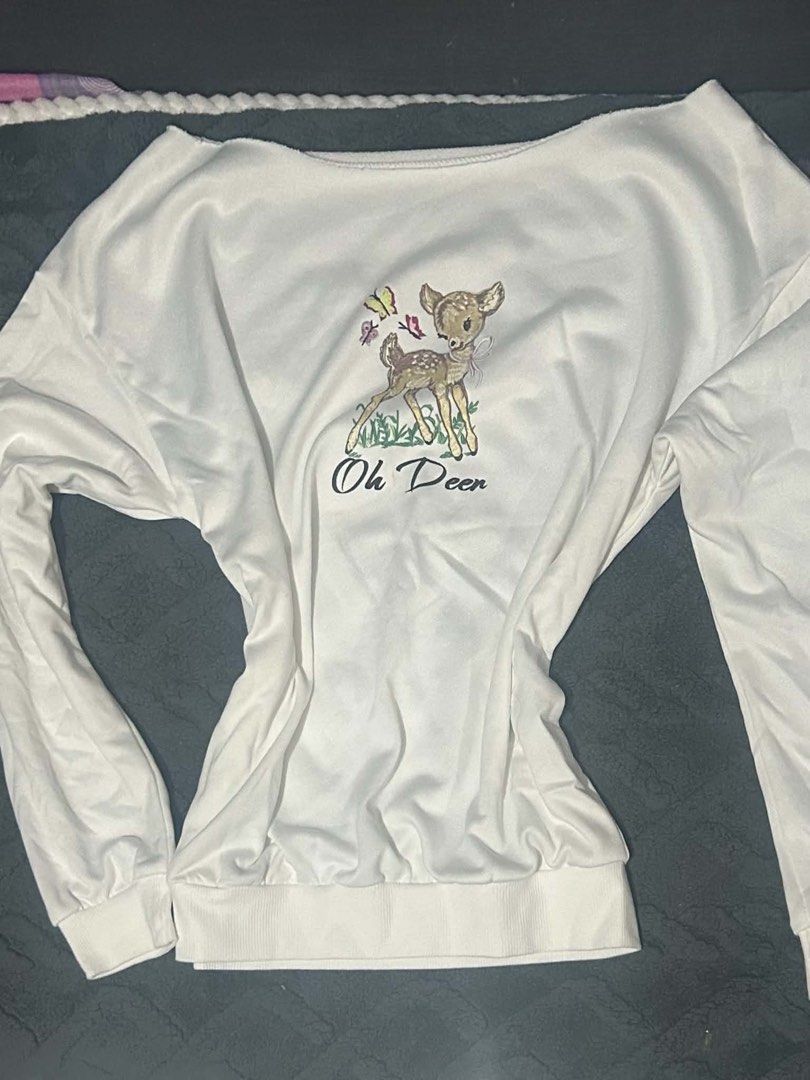 White Sweatshirt With Bambi Graphic (Category: Longsleeves) located in Manila. Submitted by yaycockroach (Listing ID 1464895690, Image 1). Description: - White long-sleeve sweatshirt with 'Oh Deer' and butterfly graphic - Comfortable wide neckline design - Ribbed cuffs and hem for a snug fit - Light and breathable material - Versatile piece, easy to match with jeans or skirts.
