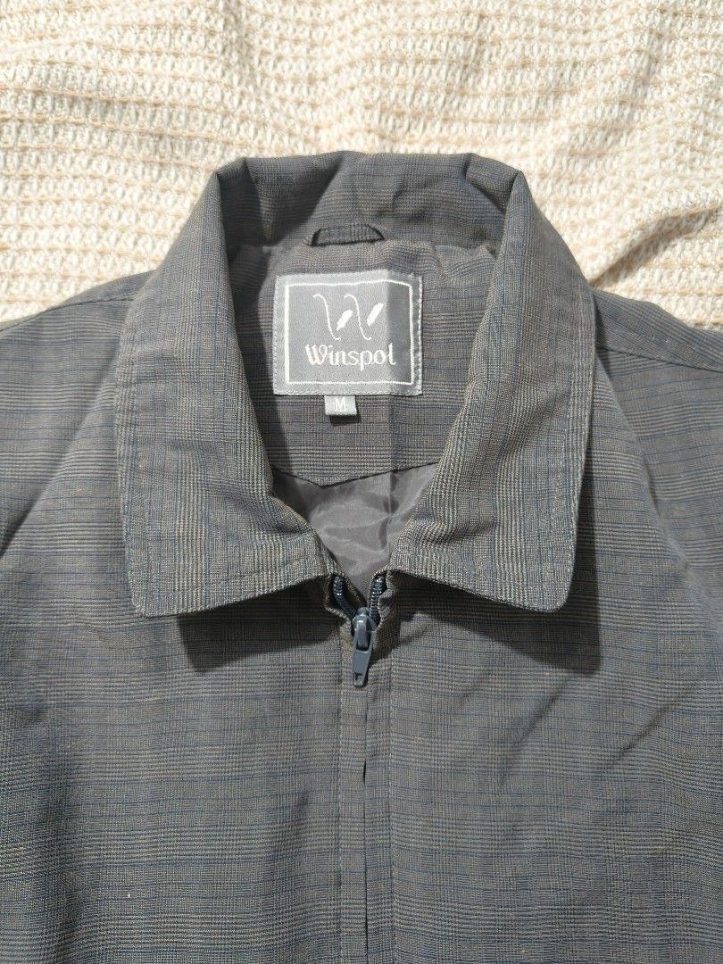 Winspol Grey Checked Casual Bomber Jacket Size M (Category: Coats, Jackets and Outerwear) located in Paranaque City. Submitted by vichhichi_ocean (Listing ID 1464809941, Image 3). Description: - Brand: Winspol - Color: Dark grey with subtle checked pattern - Size: Medium (M) - Closure: Full zip front with classic collar - Features: Elasticated waistband, button cuffs, and inner lining - Condition: Clean fabric texture throughout.